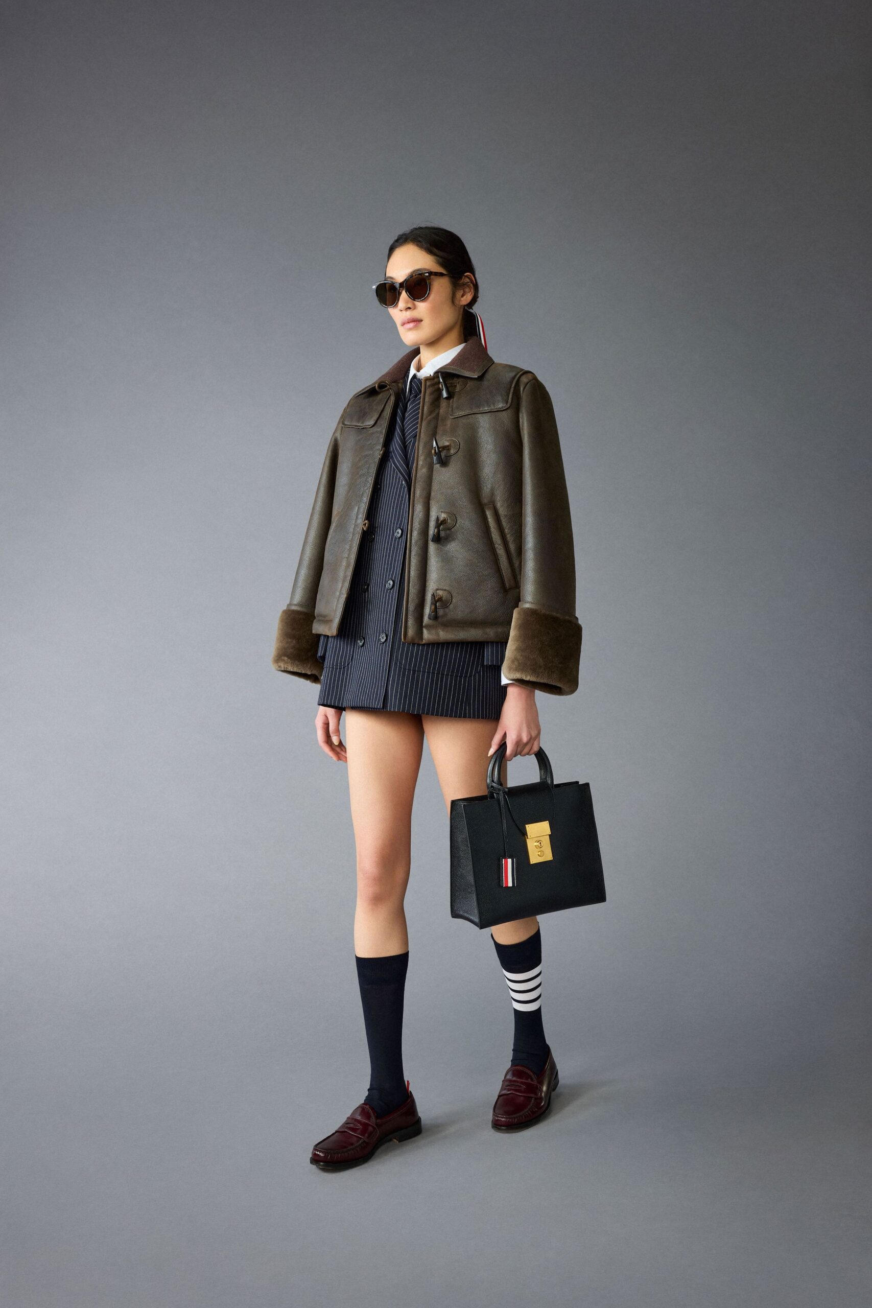brown leather jacket with black shorts