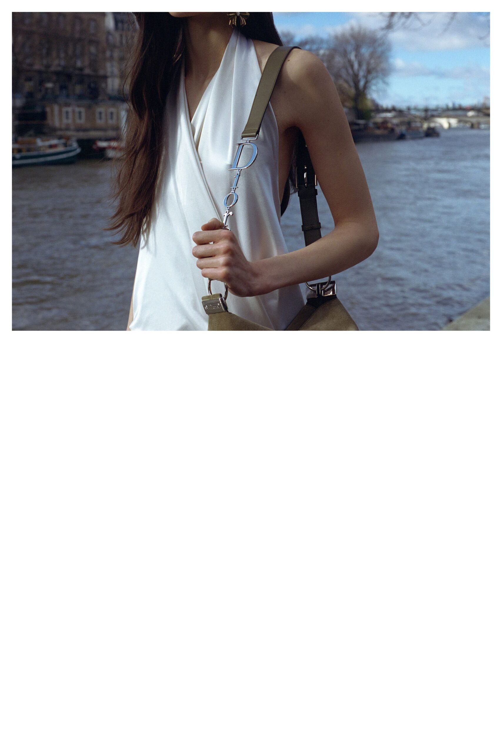 white silk sleeveless top with beige bag