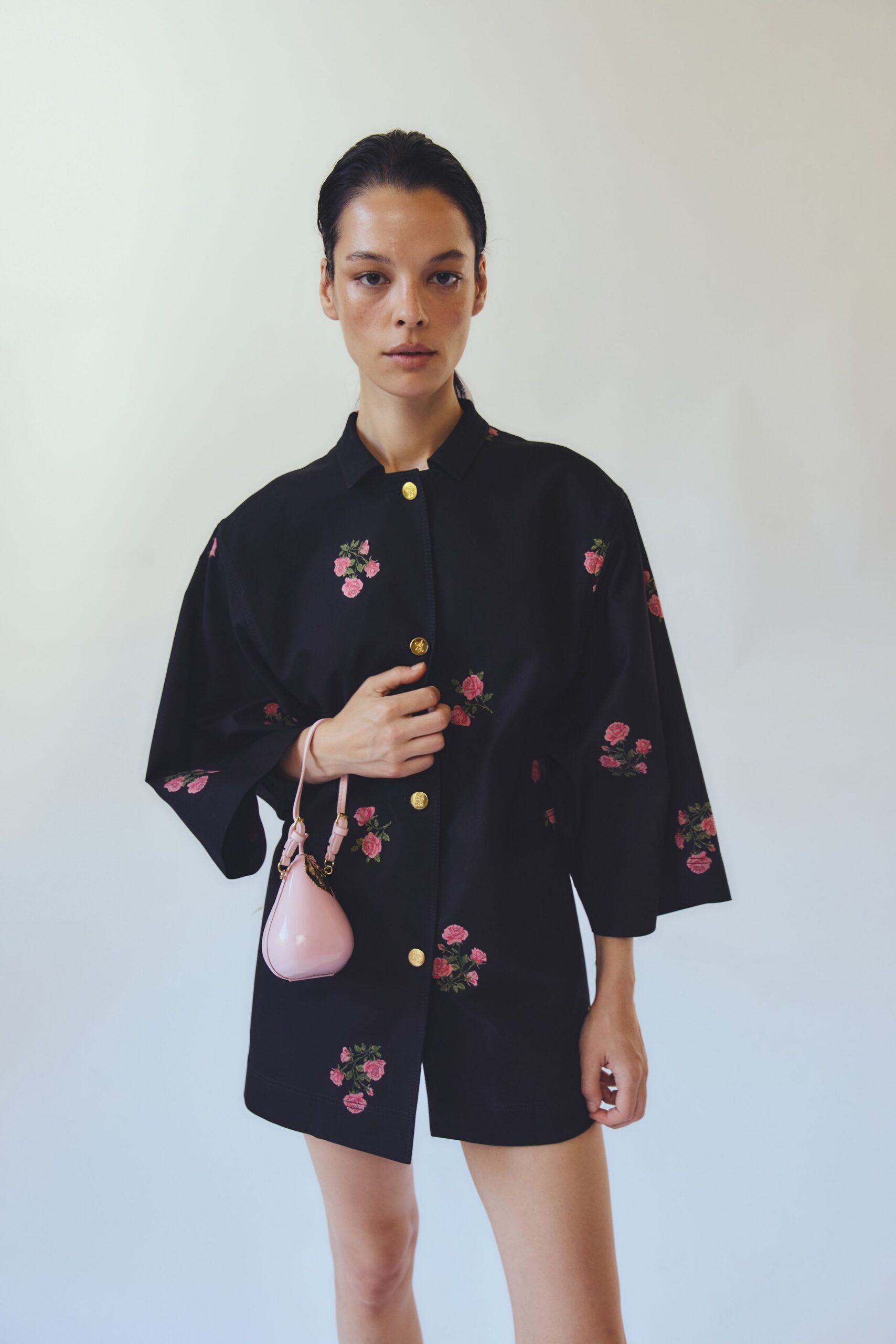 black embroidered jacket with pink bag