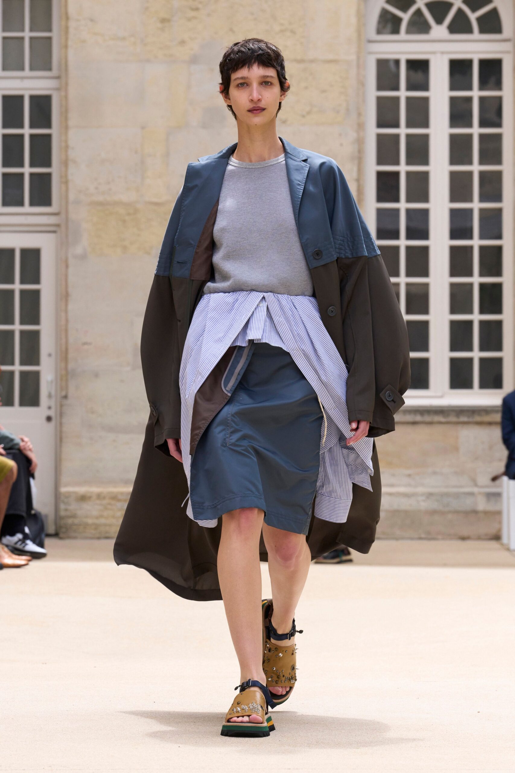 brown coat gray sweater blue skirt