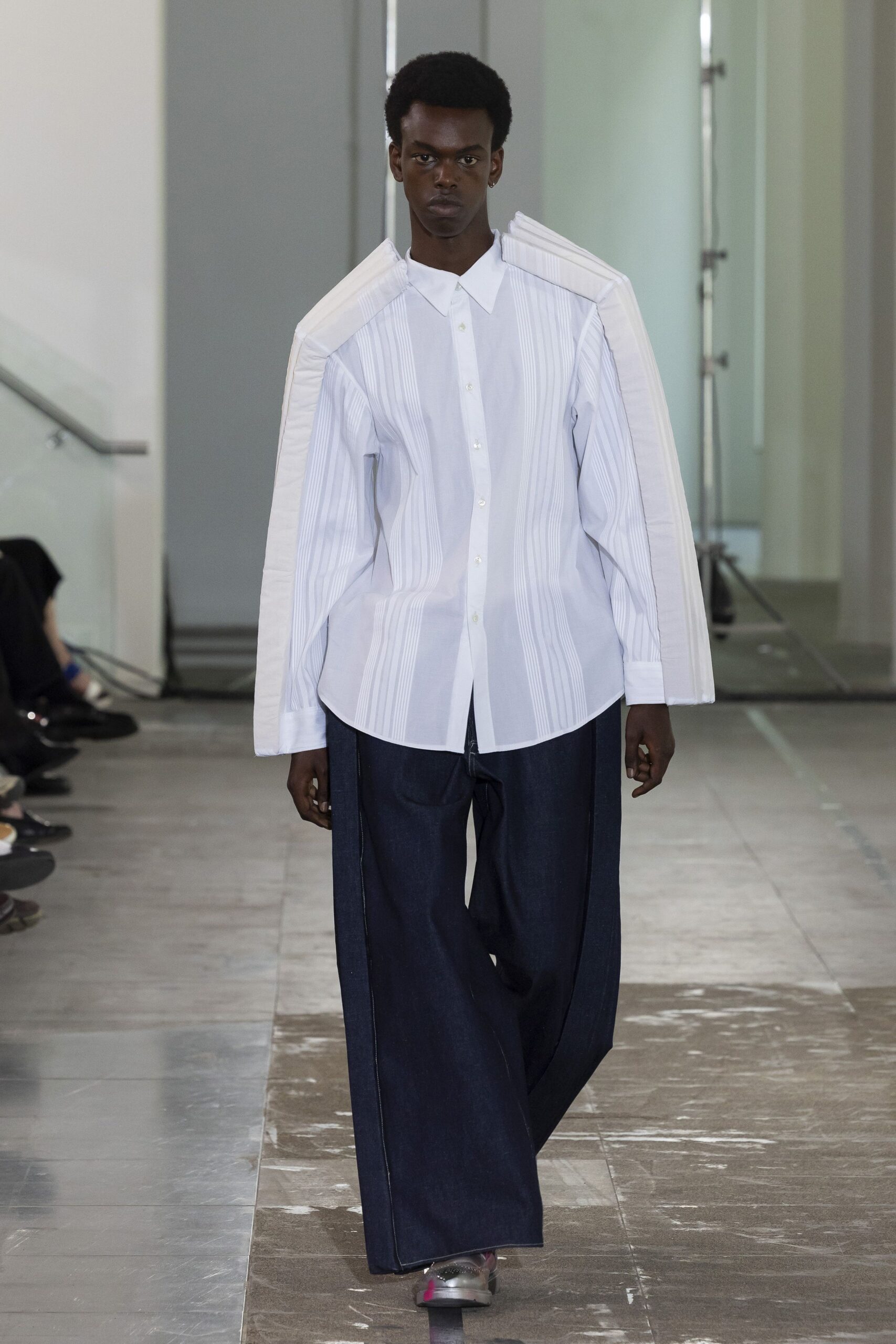 white pleated shirt and blue denim pants