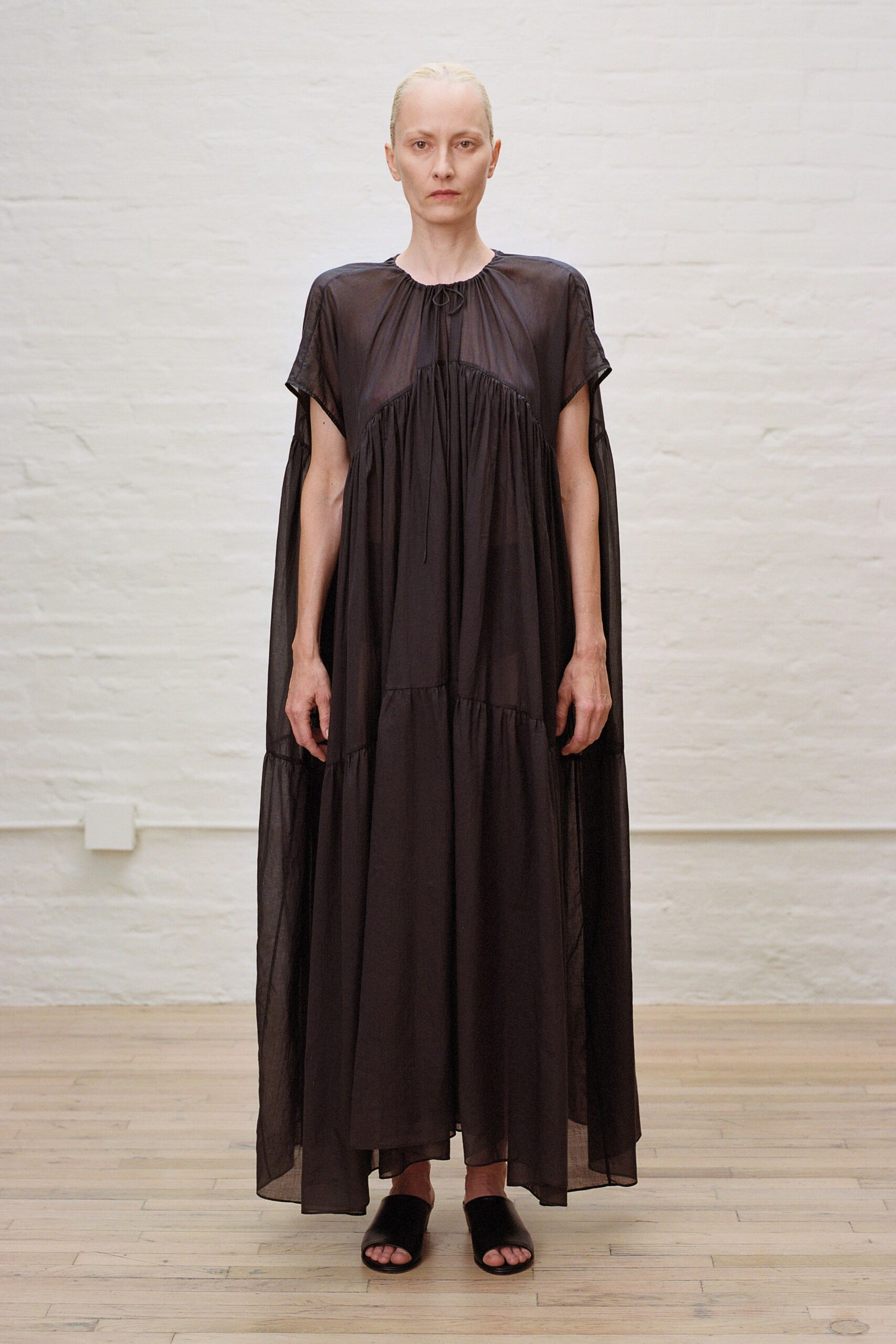 black flowing maxi dress with open-toe shoes