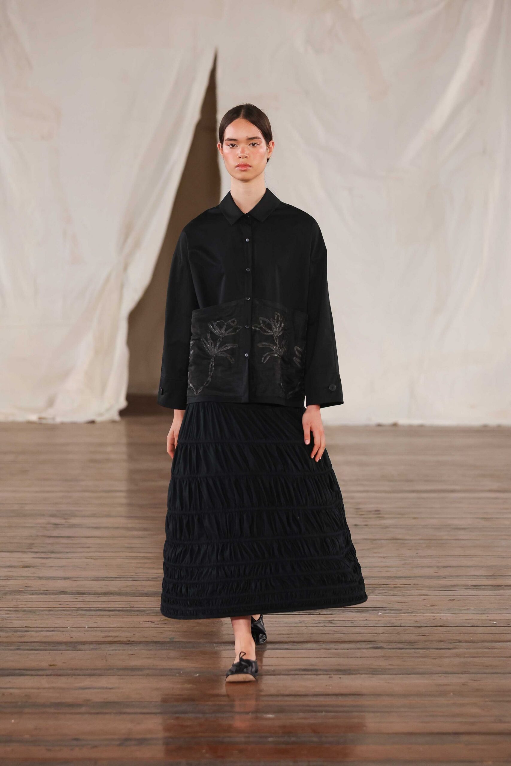 black relaxed shirt and tiered skirt