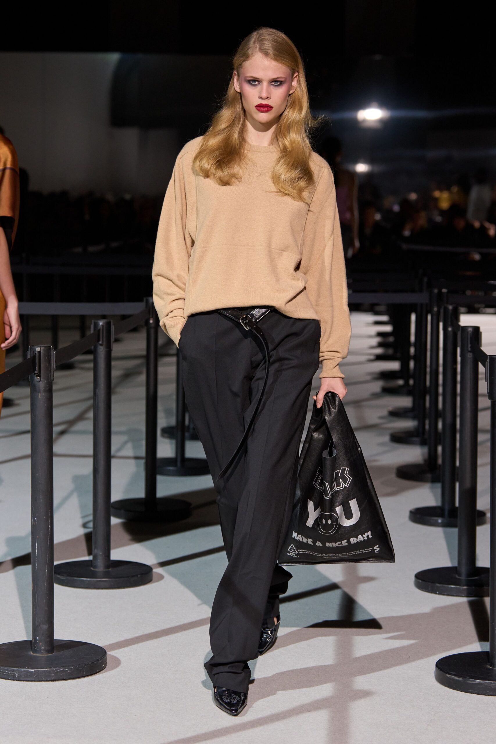 beige relaxed sweater black pants