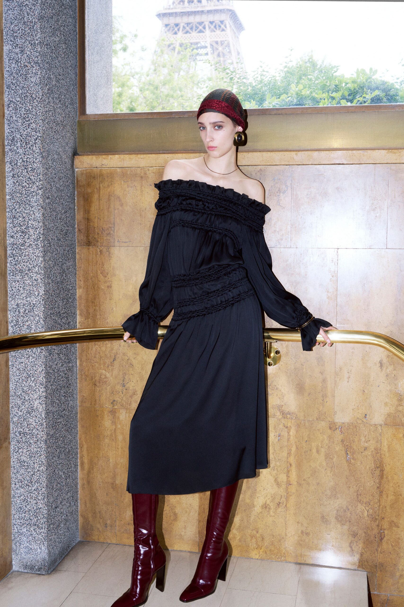 black off-shoulder midi dress with red boots