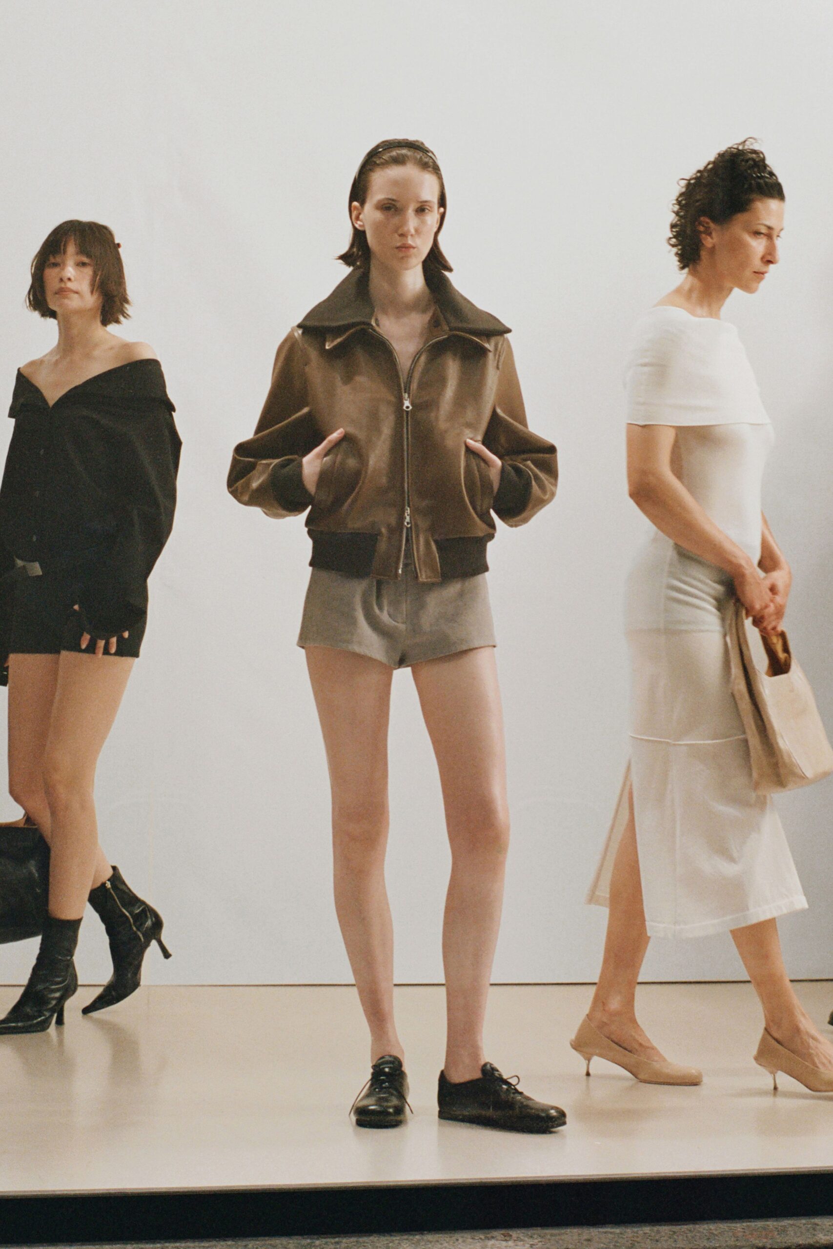 brown leather jacket with gray shorts