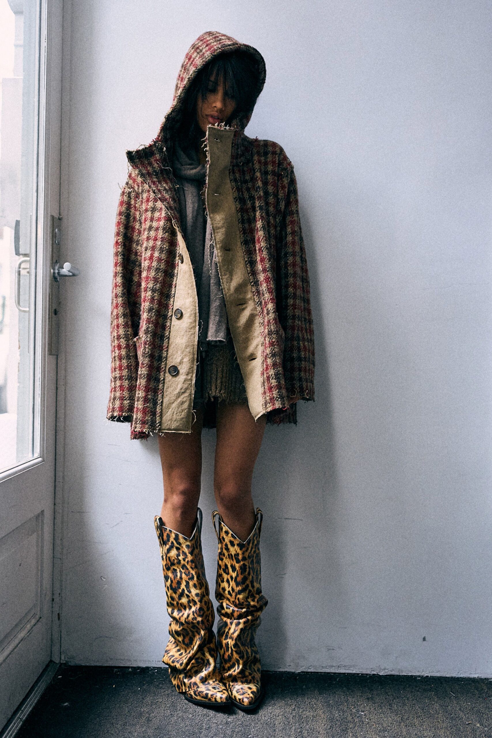 checked coat with animal-print boots