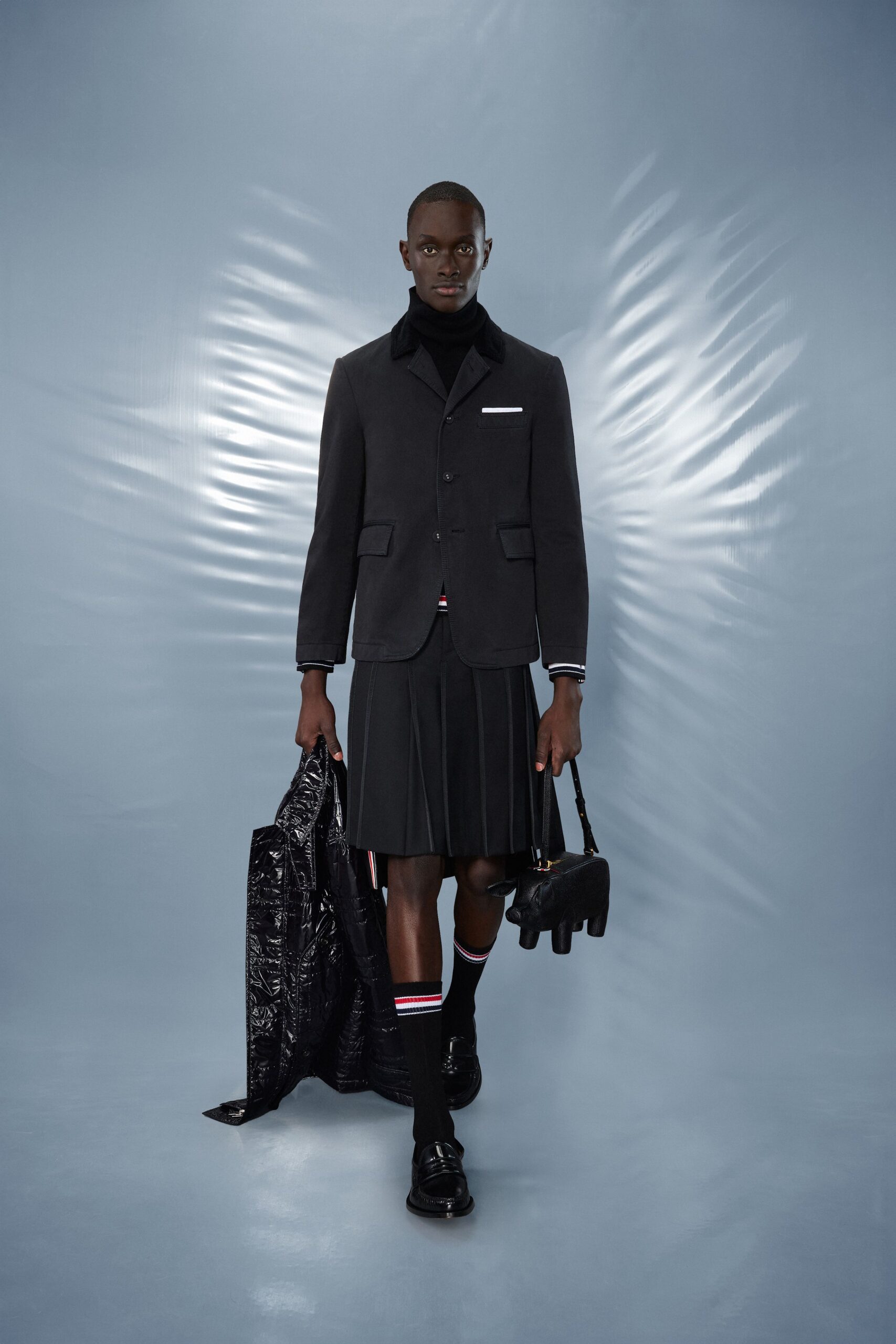black tailored blazer and pleated skirt