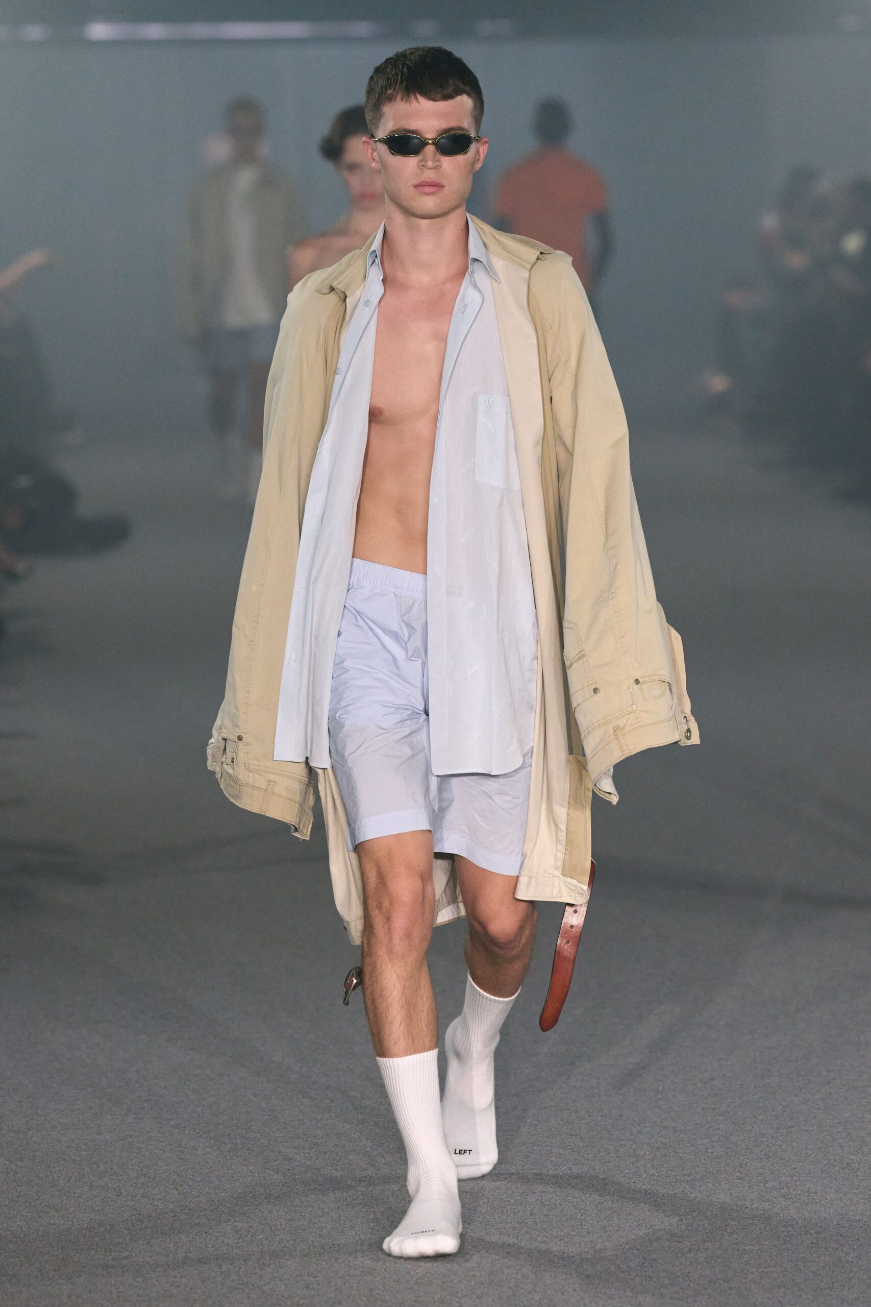 beige coat with light blue shirt and shorts