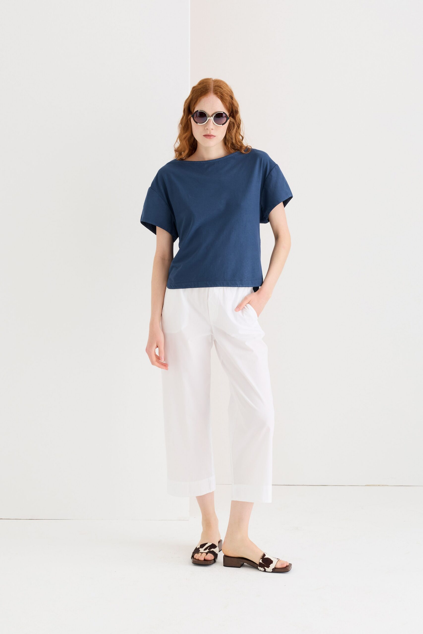 blue cotton relaxed top with white pants