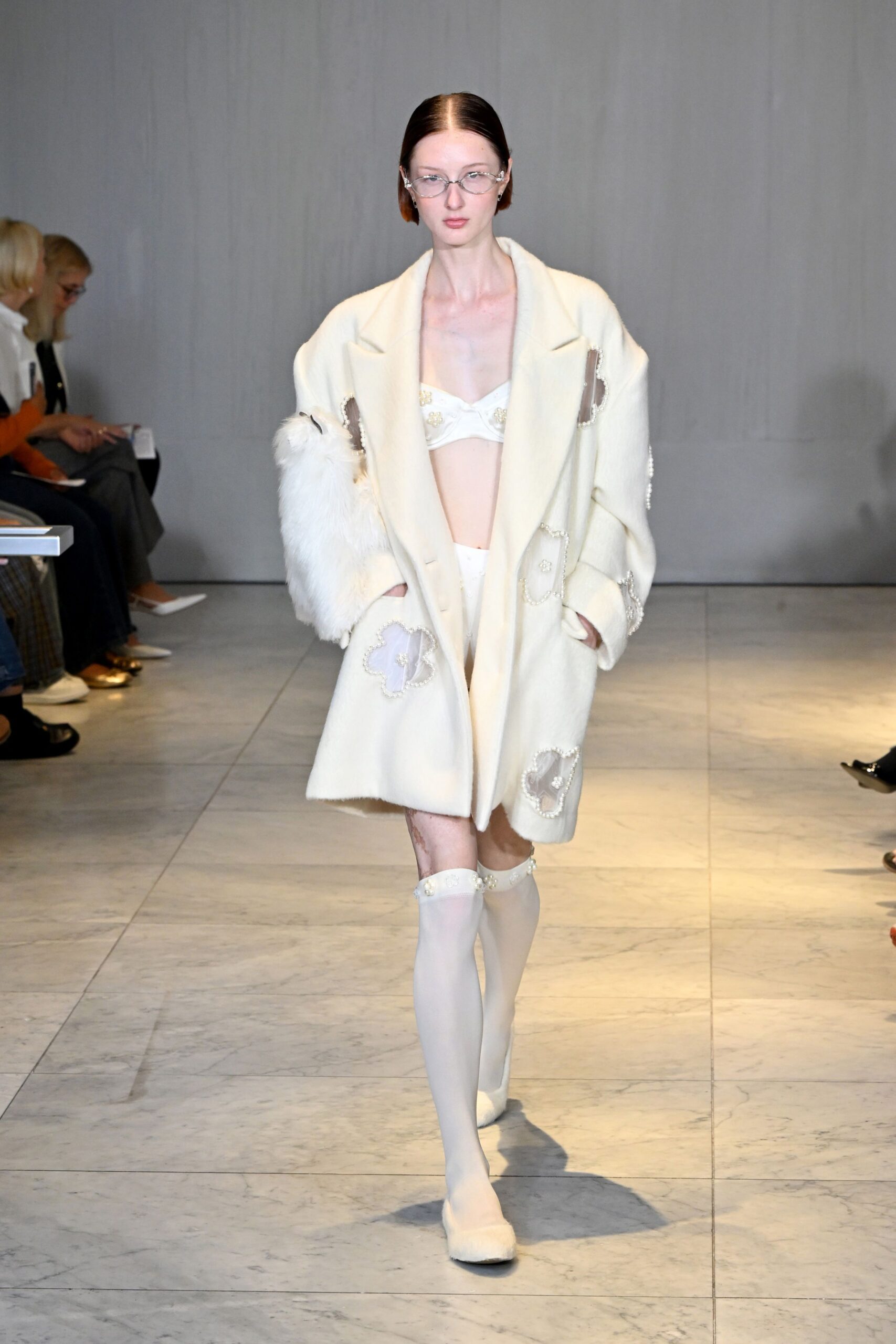white wool coat with beige bra