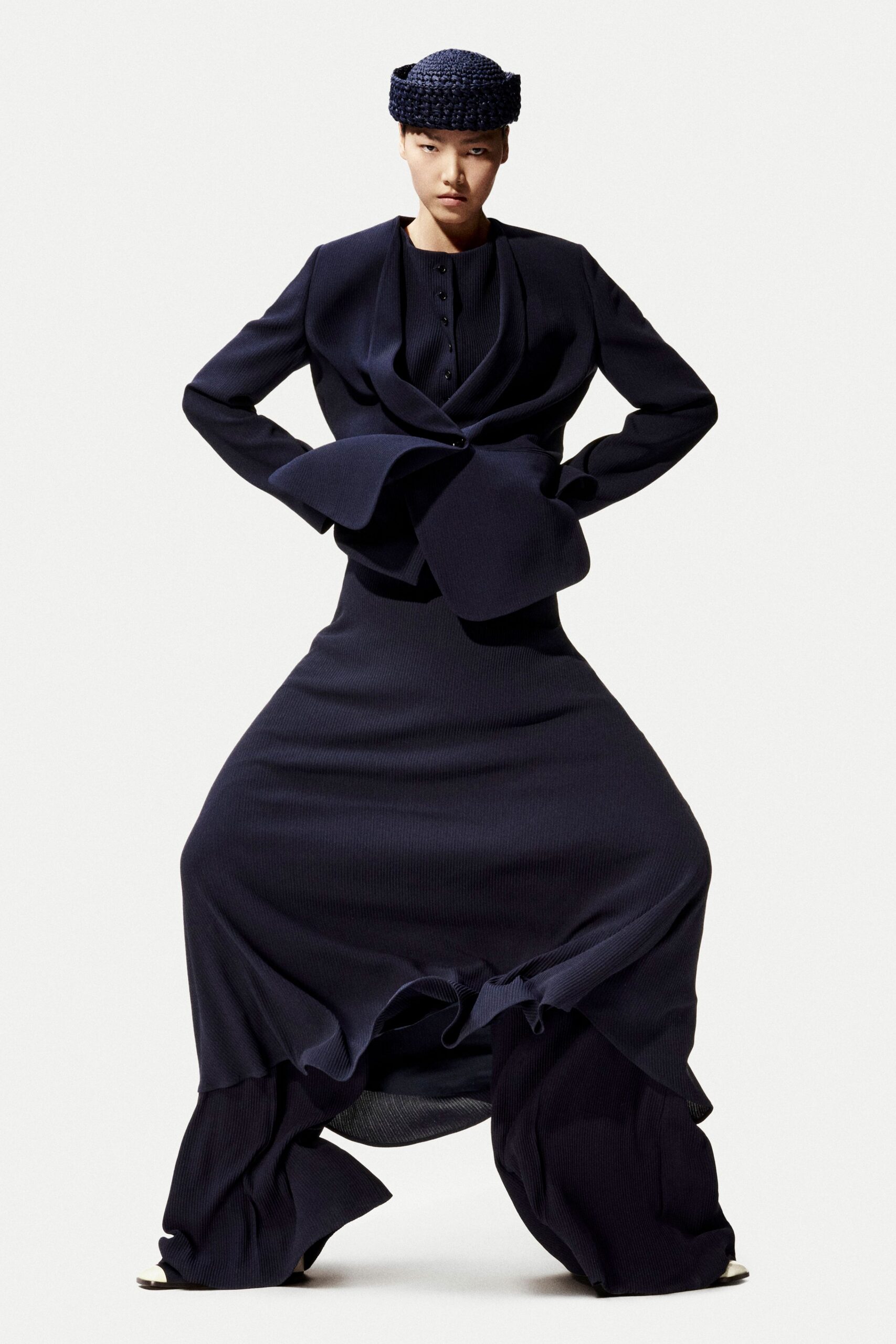 black structured jacket and flared skirt