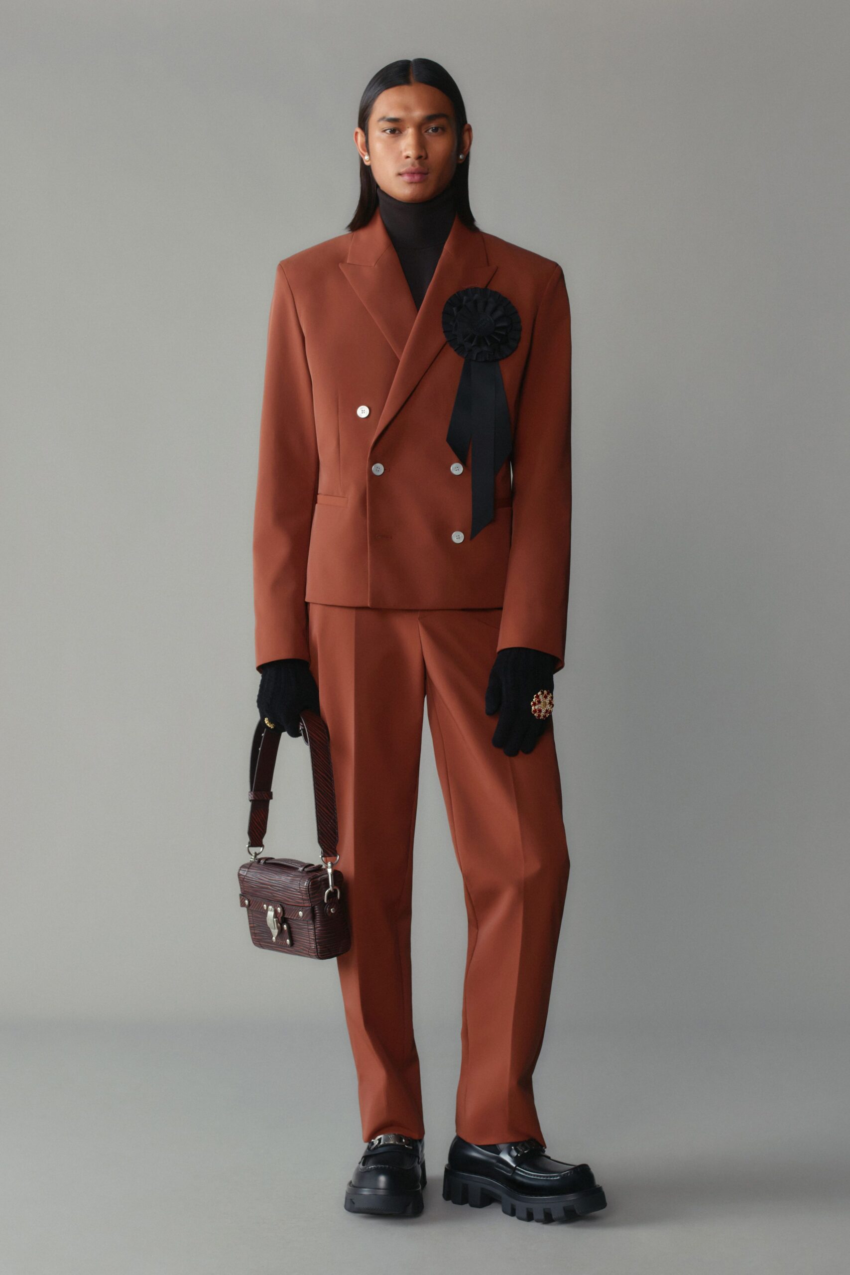 brown tailored suit with gloves