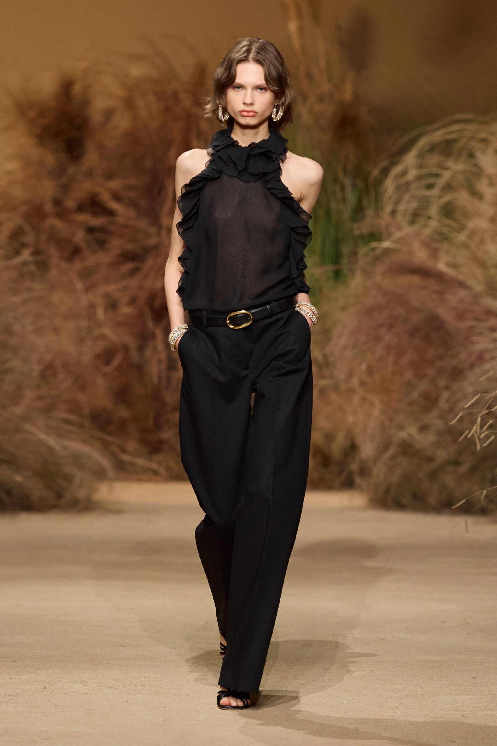 black ruffled top with tailored pants