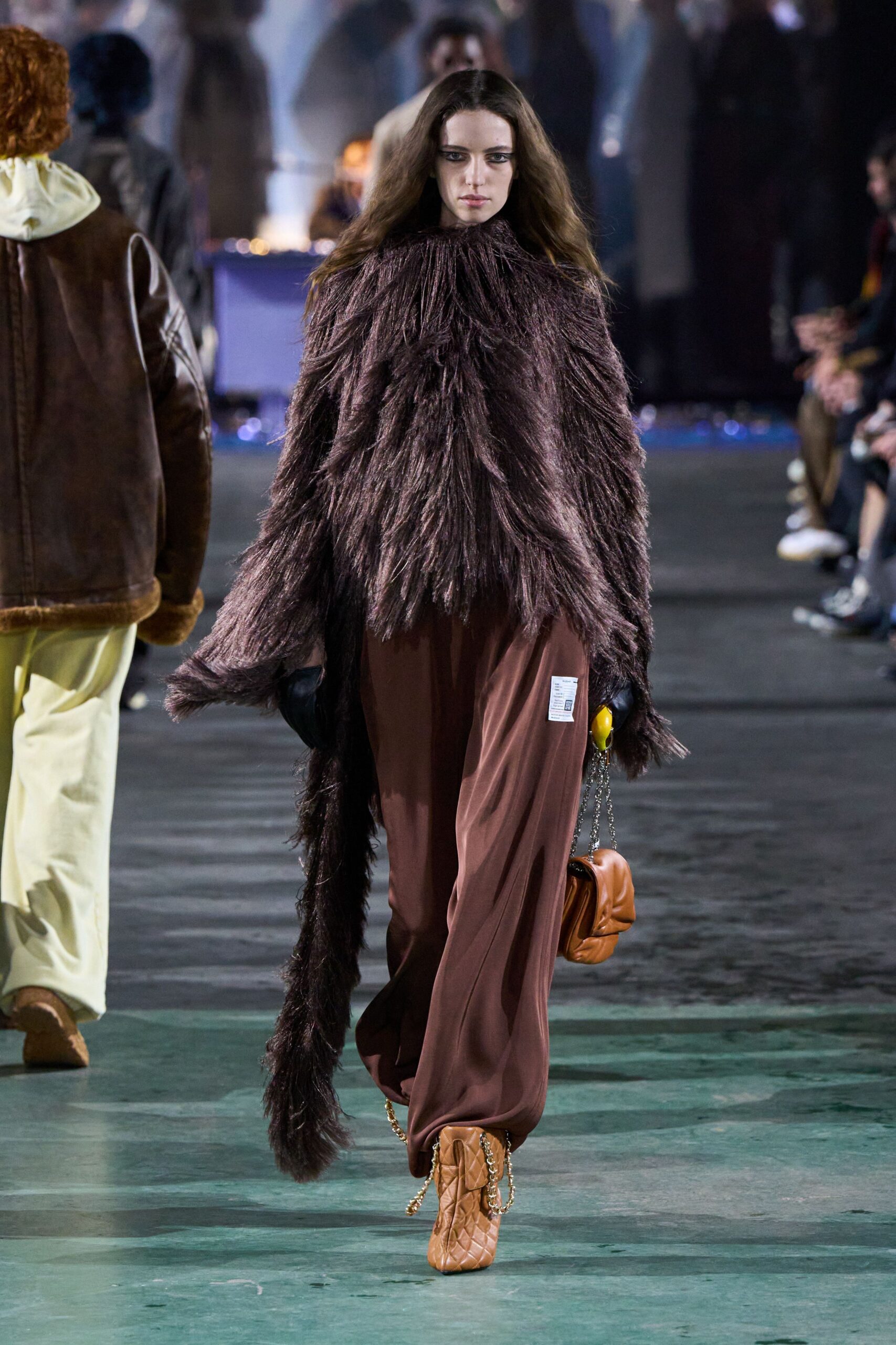 brown faux-fur cape with relaxed pants