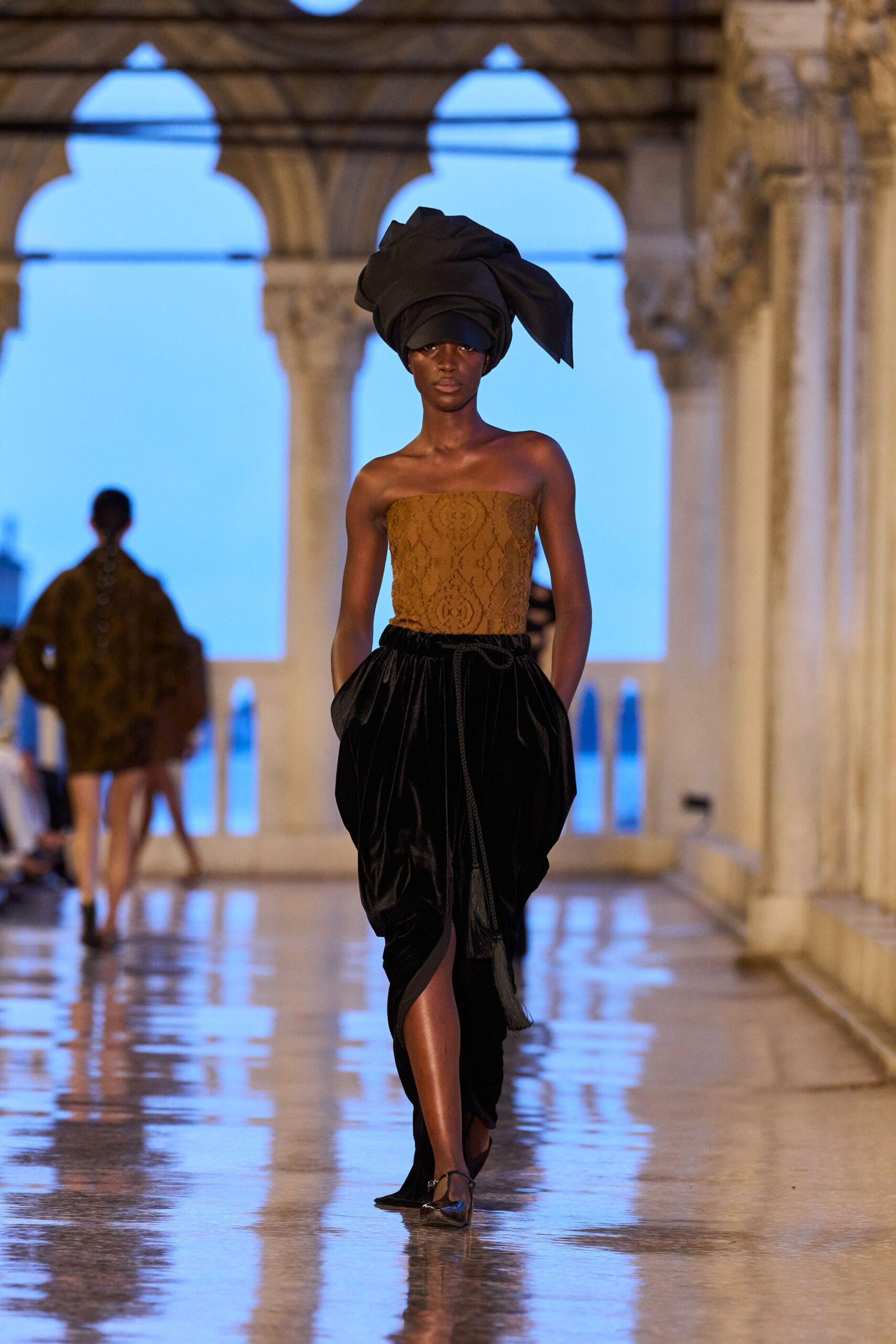 brown lace sleeveless top with black skirt