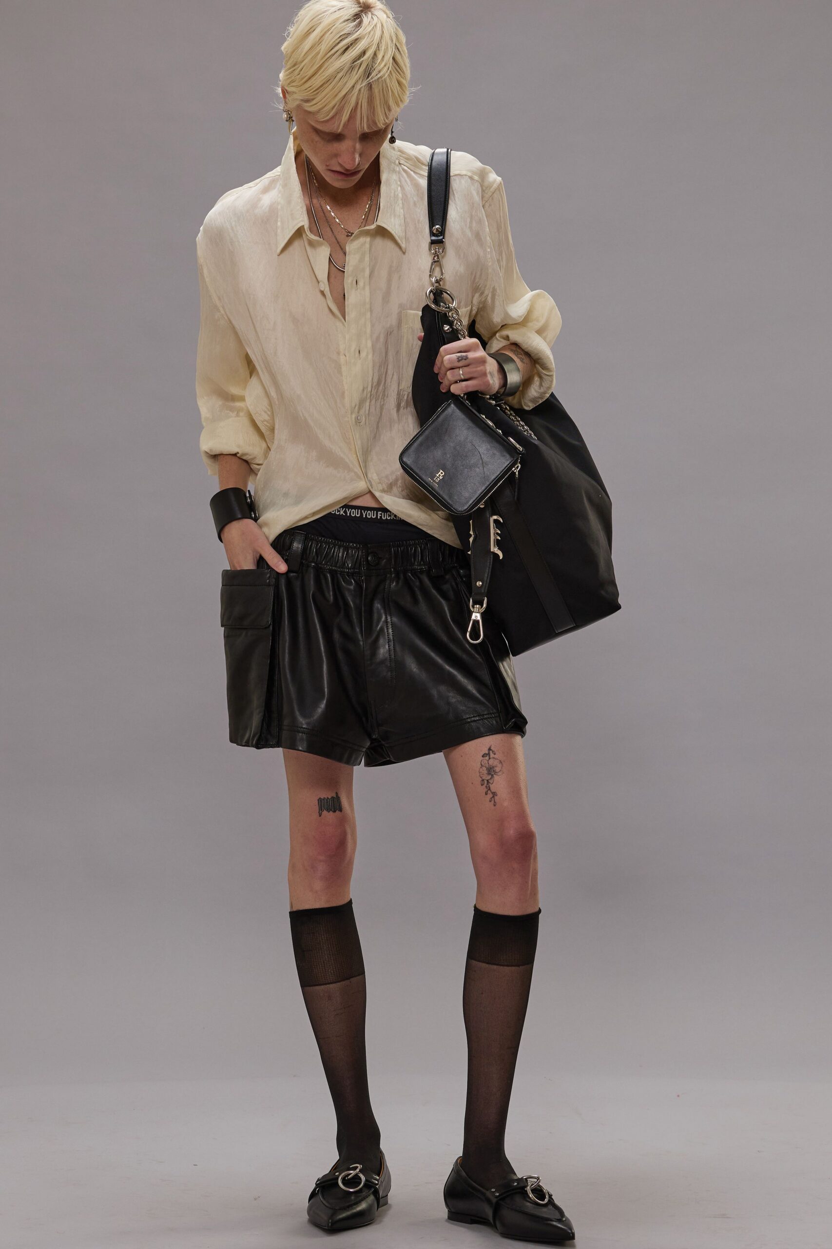 beige relaxed shirt with black leather shorts