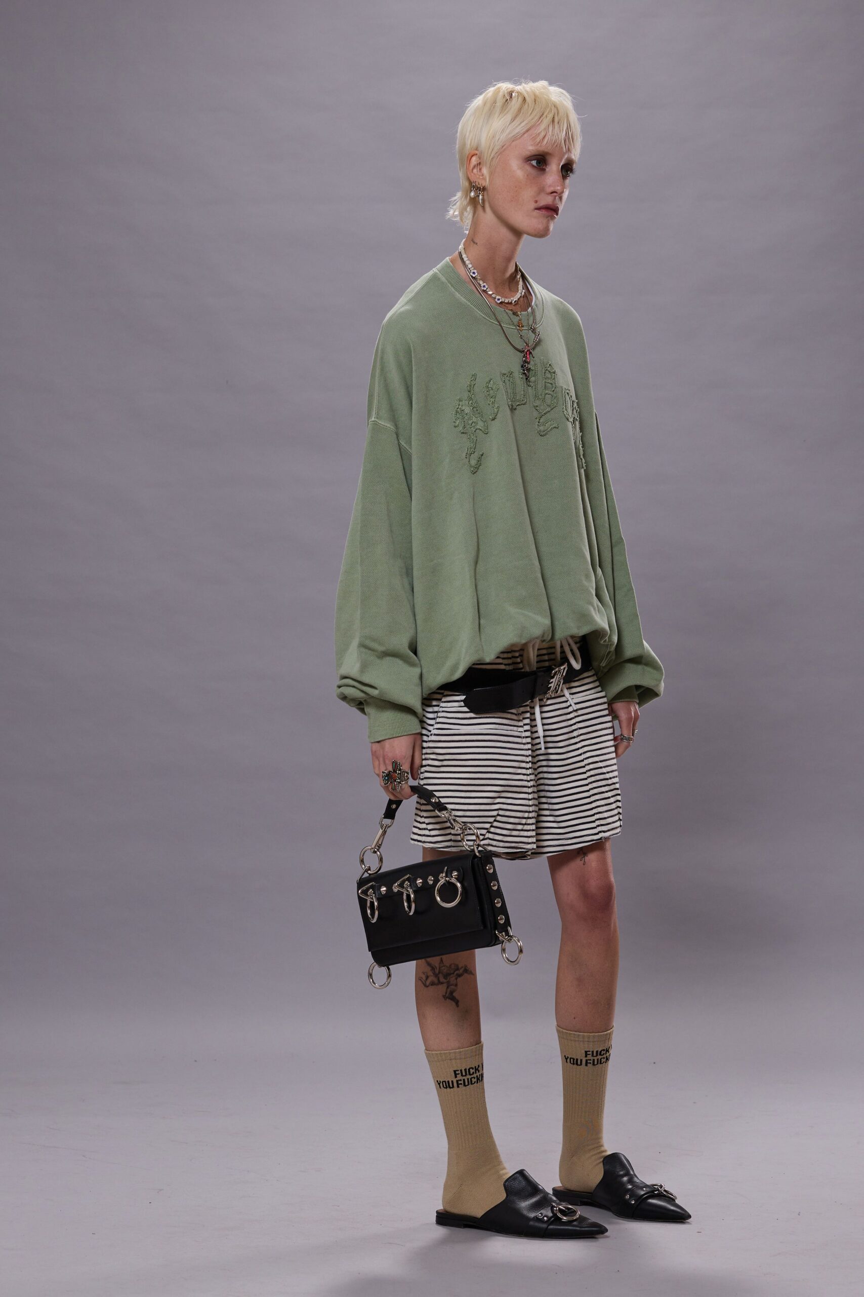 oversized green sweater with striped shorts