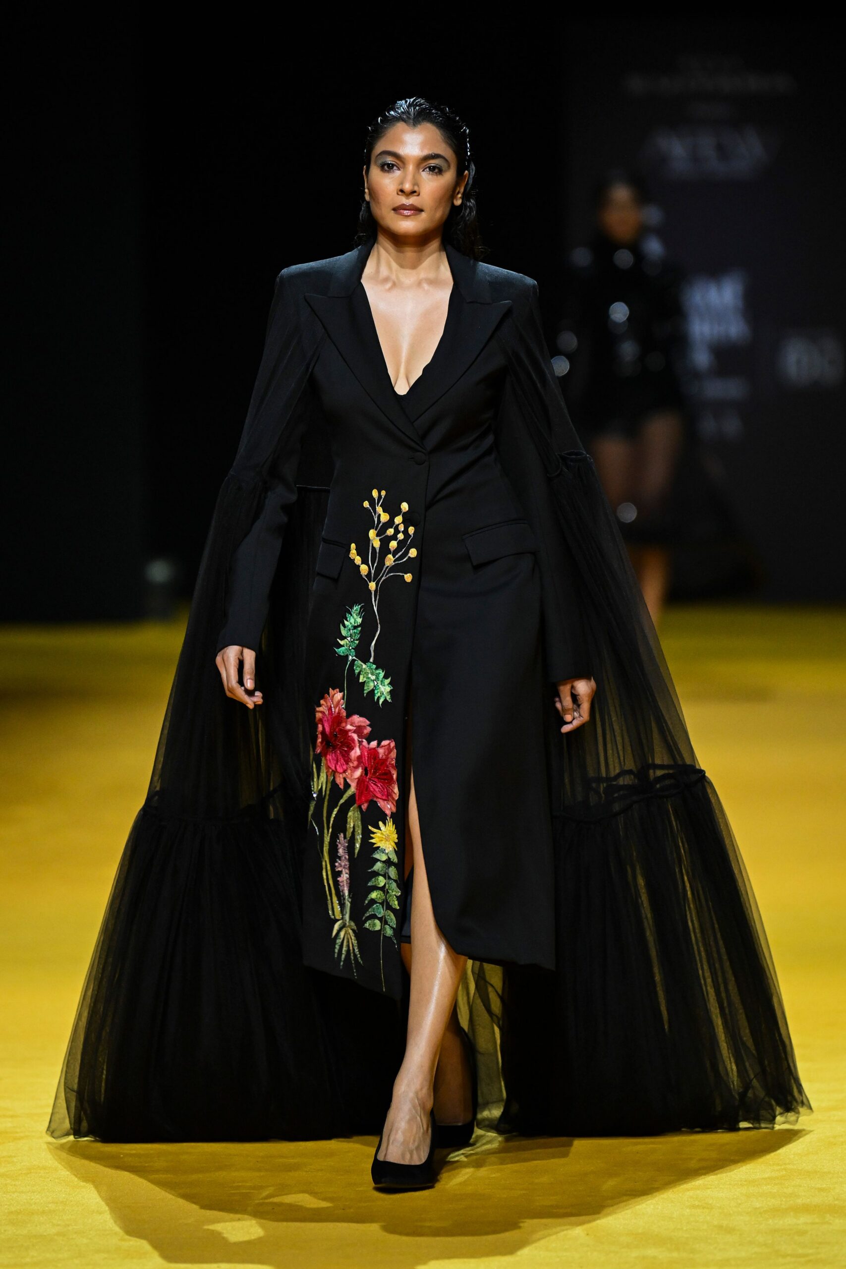 black embroidered gown with flowing sleeves
