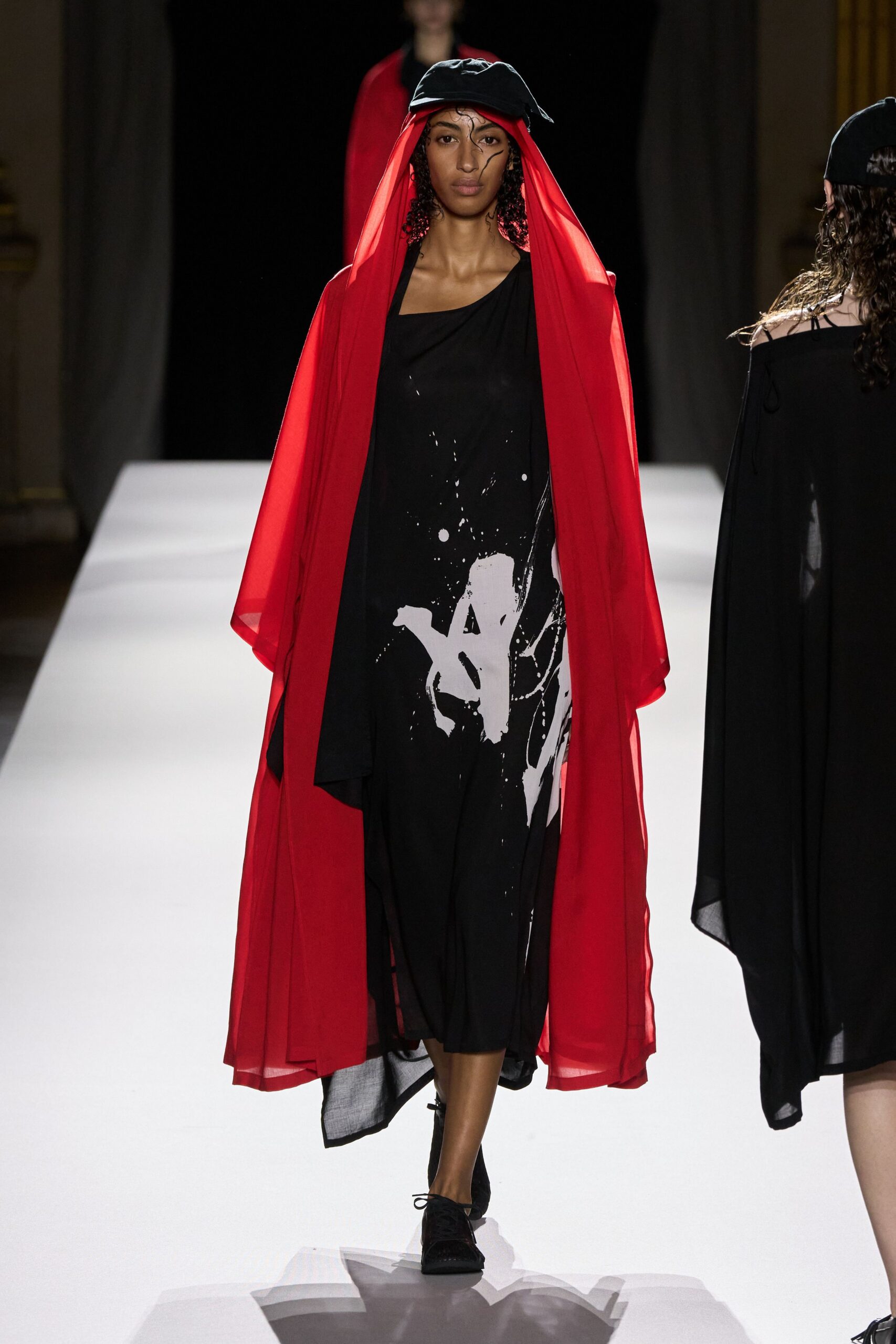 black midi dress with red cape