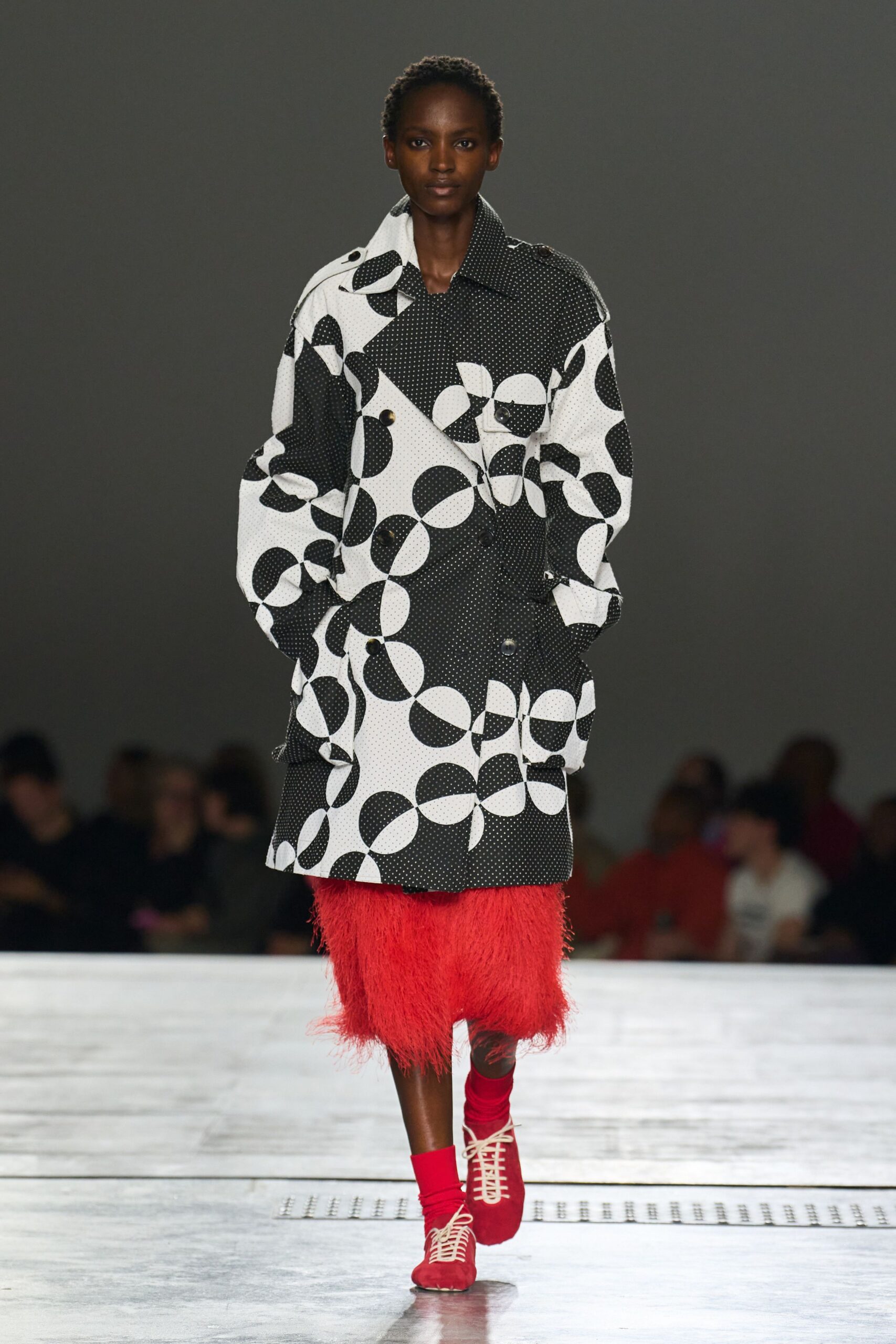 black and white printed coat with red skirt