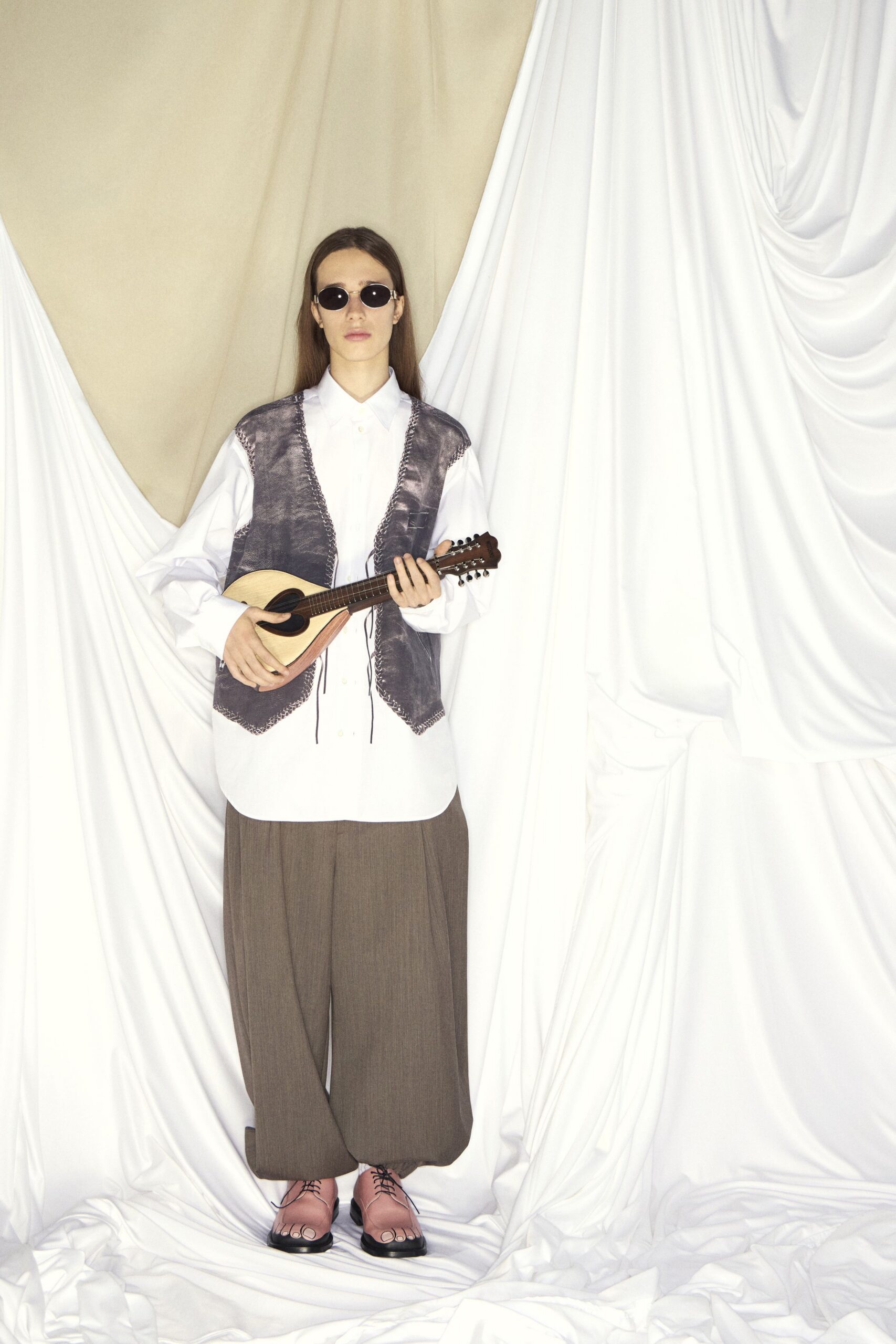 white shirt gray vest brown pants