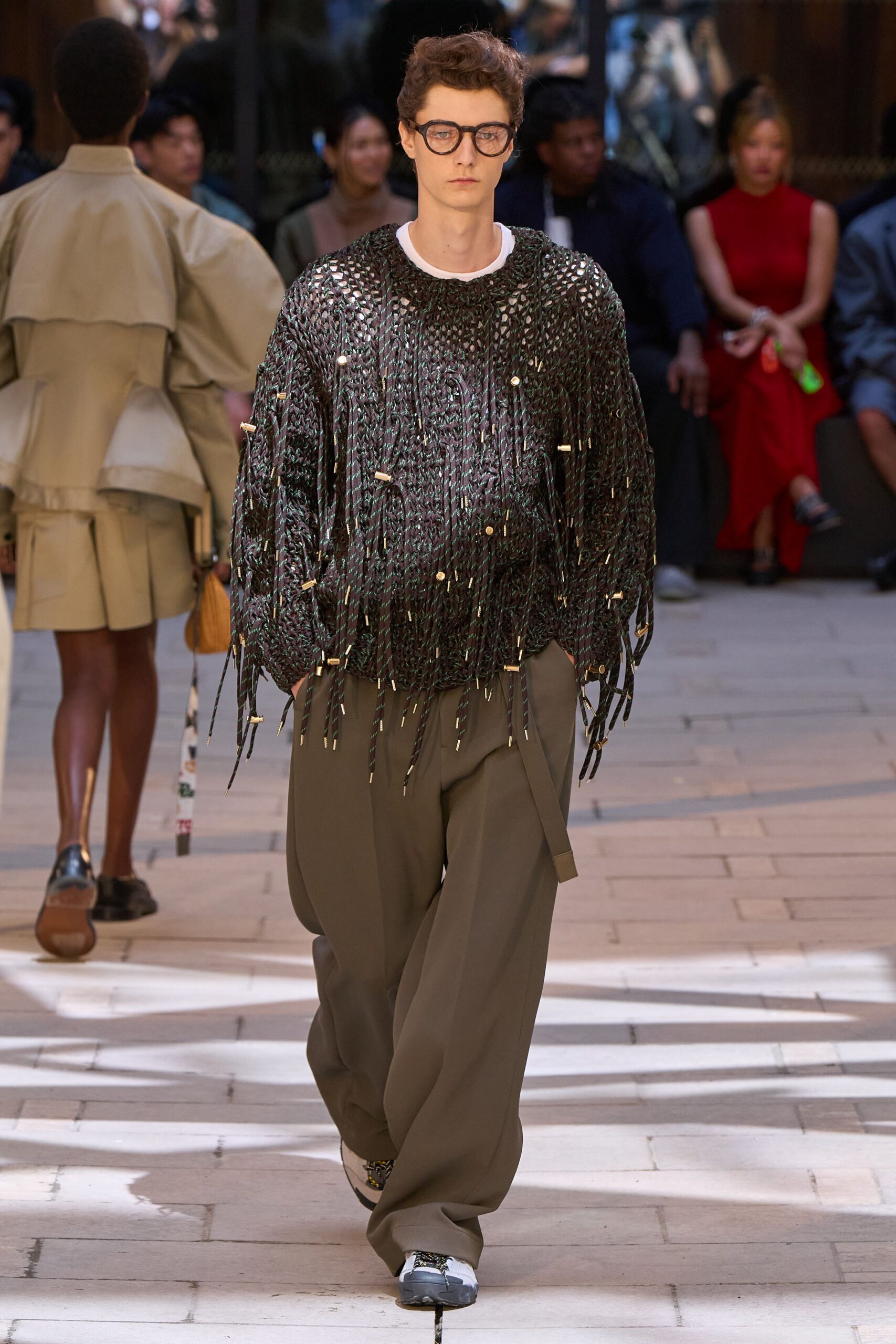 black fringed sweater with gray pants
