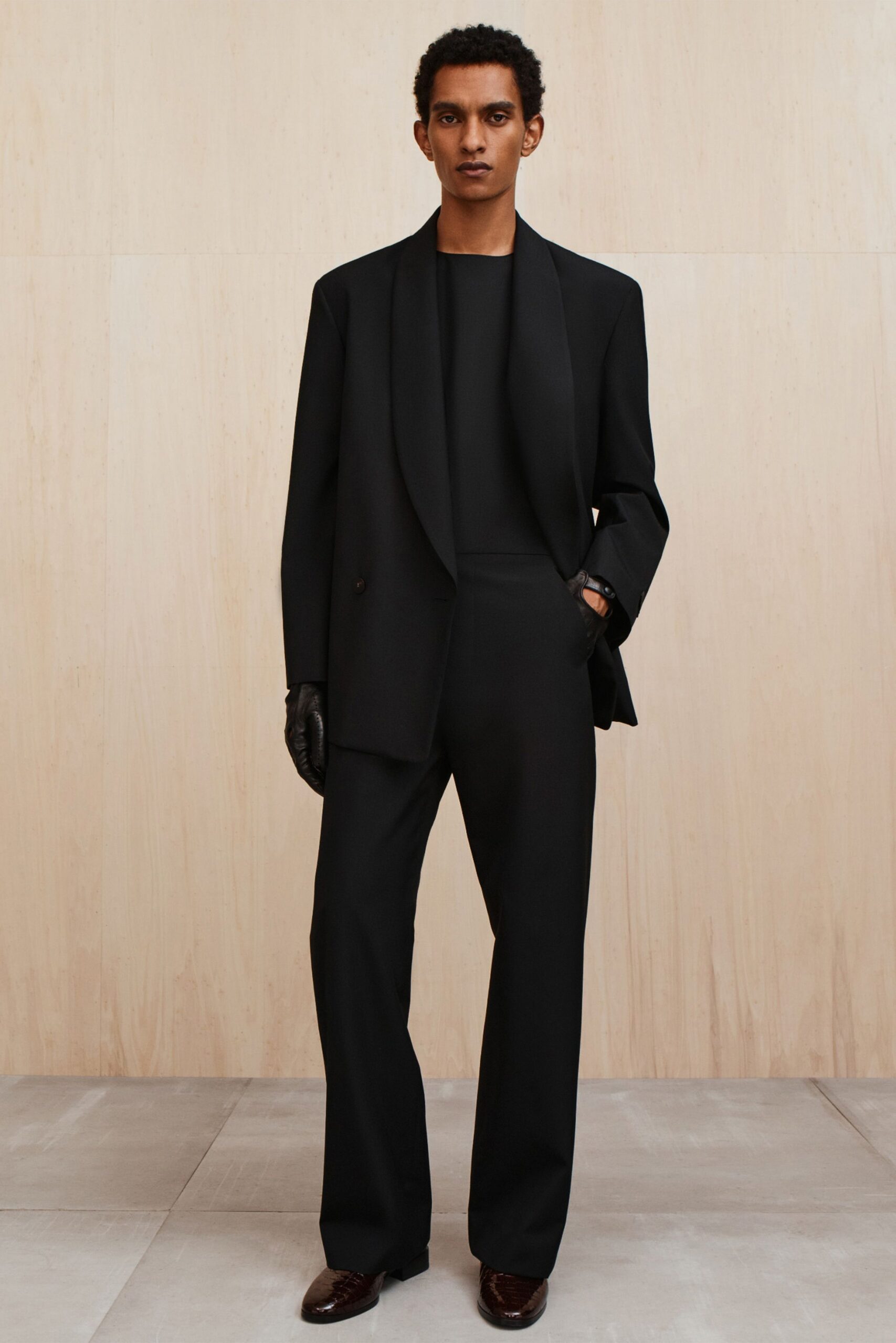 black tailored suit with gloves