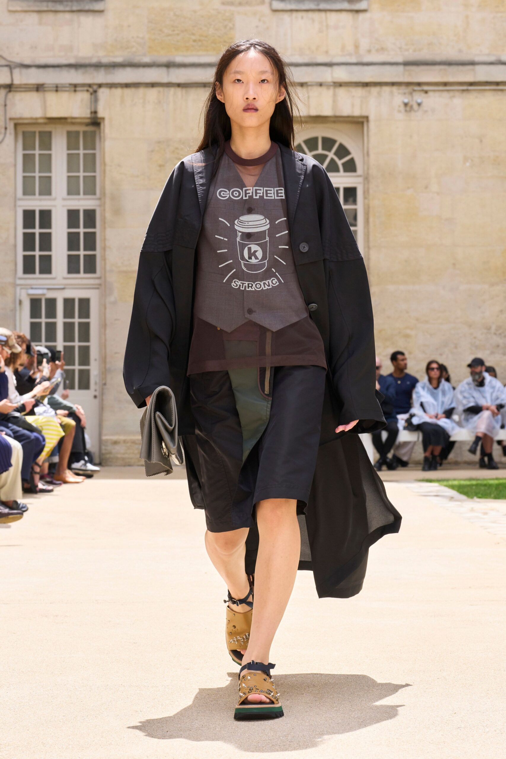 black coat gray t-shirt black shorts