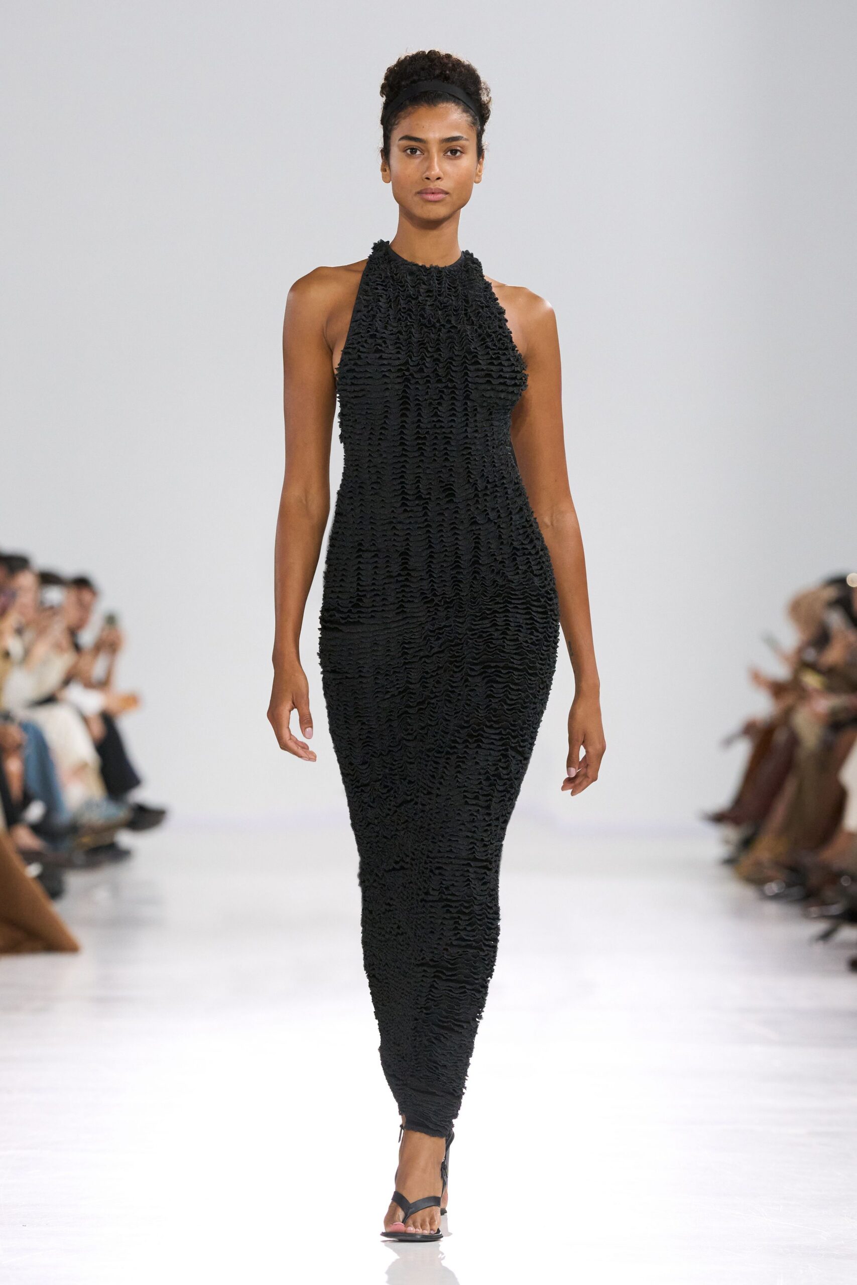 black fitted ruched gown with strappy shoes