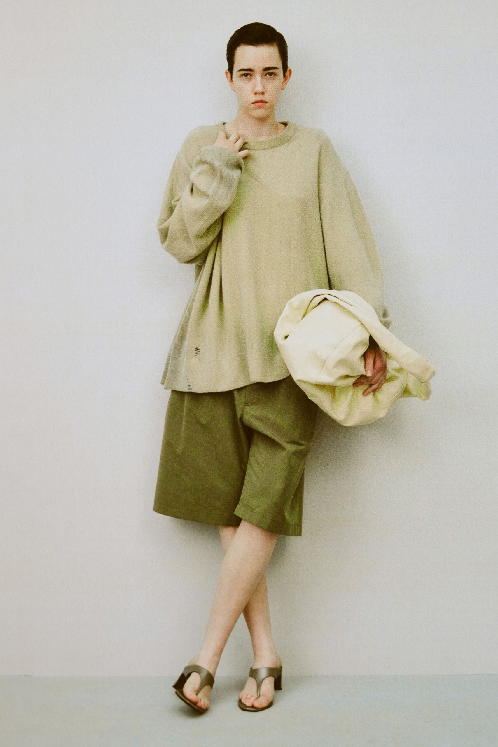 beige oversized top with green shorts