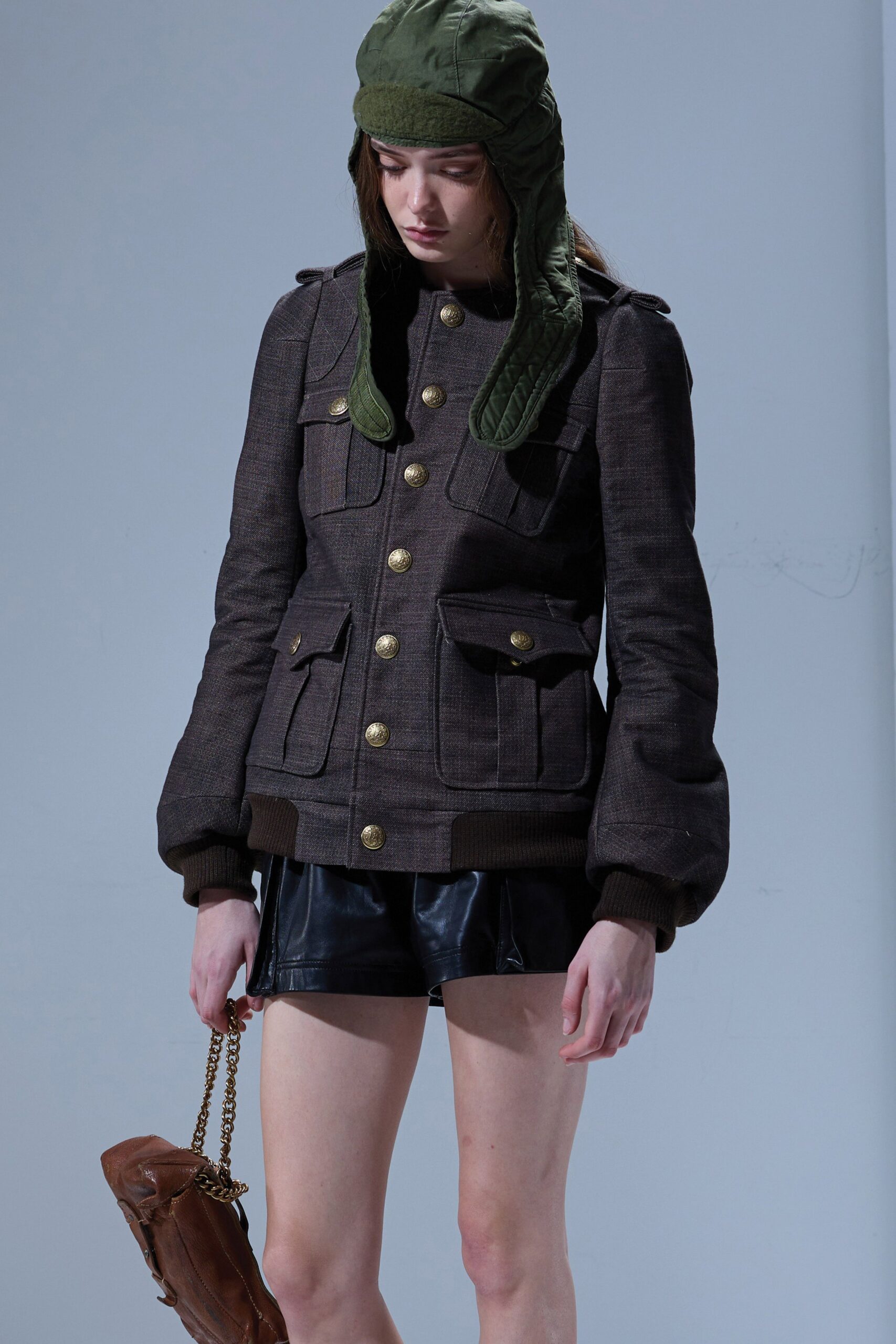 brown fitted jacket with black shorts