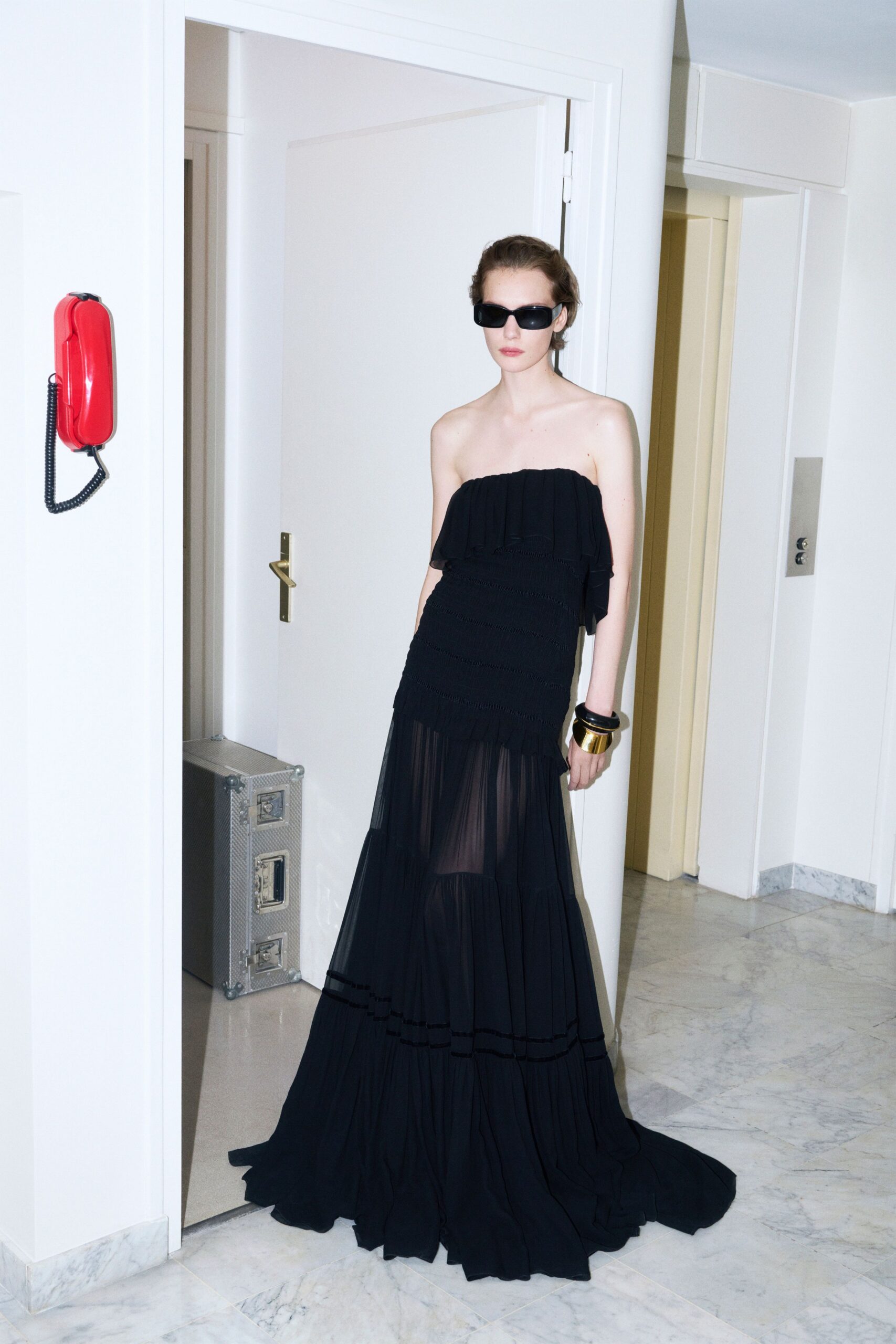 black chiffon strapless fitted ruffled layered flowing gown