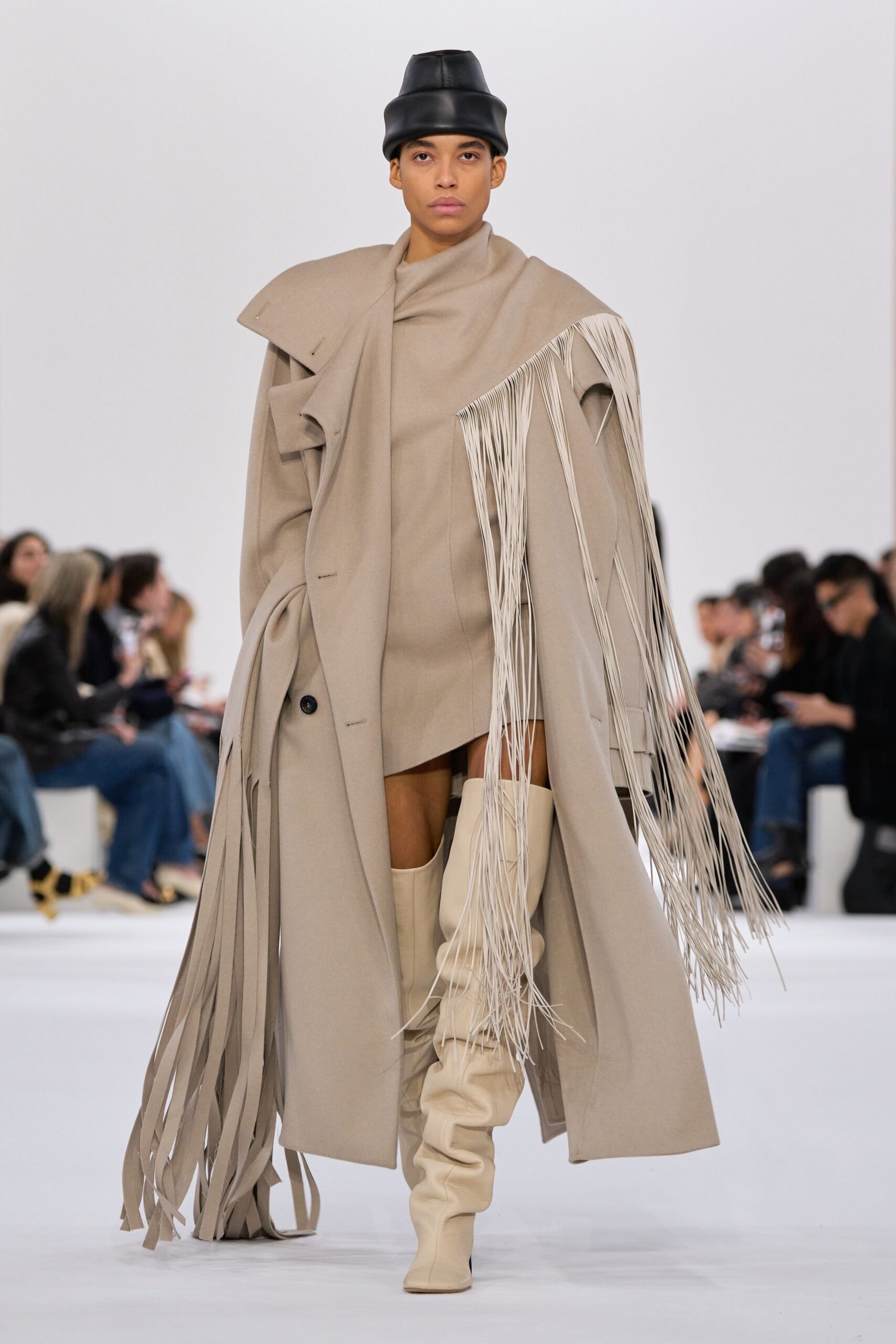 beige coat with fringes and white boots