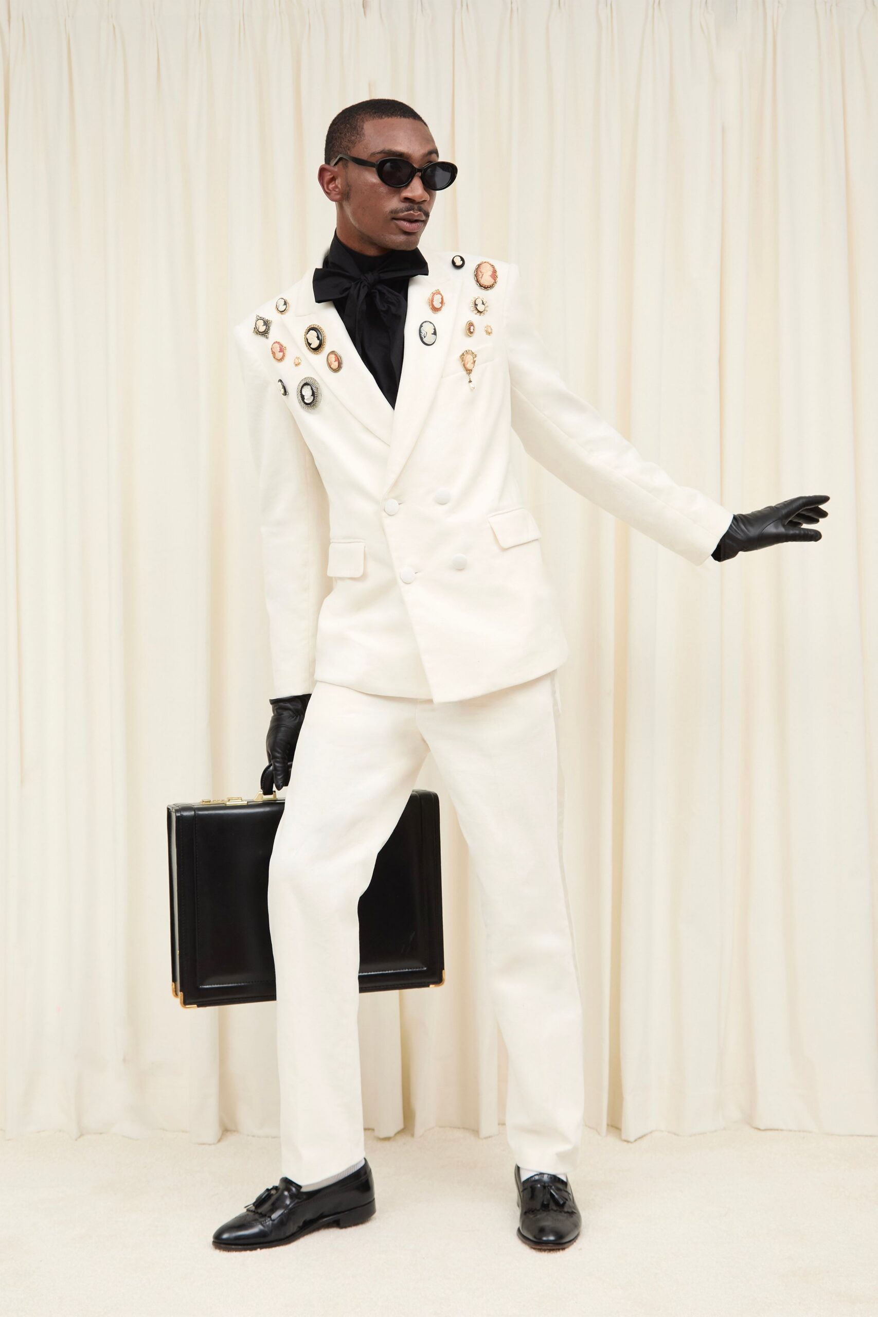 white tailored suit with black accessories