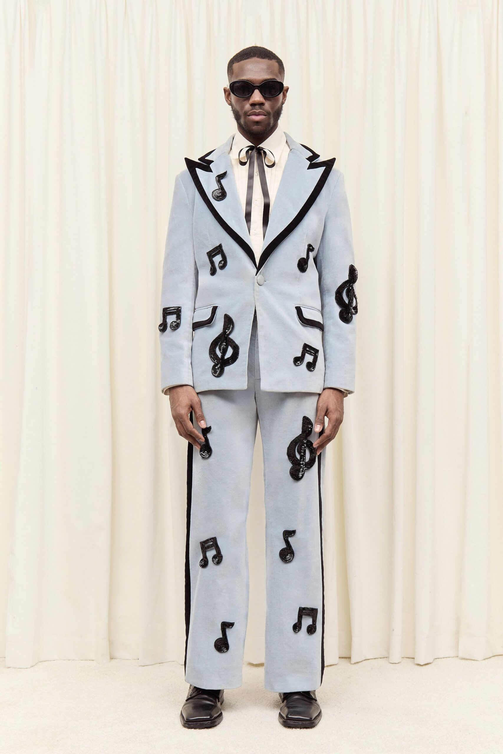 blue tailored suit with musical notes