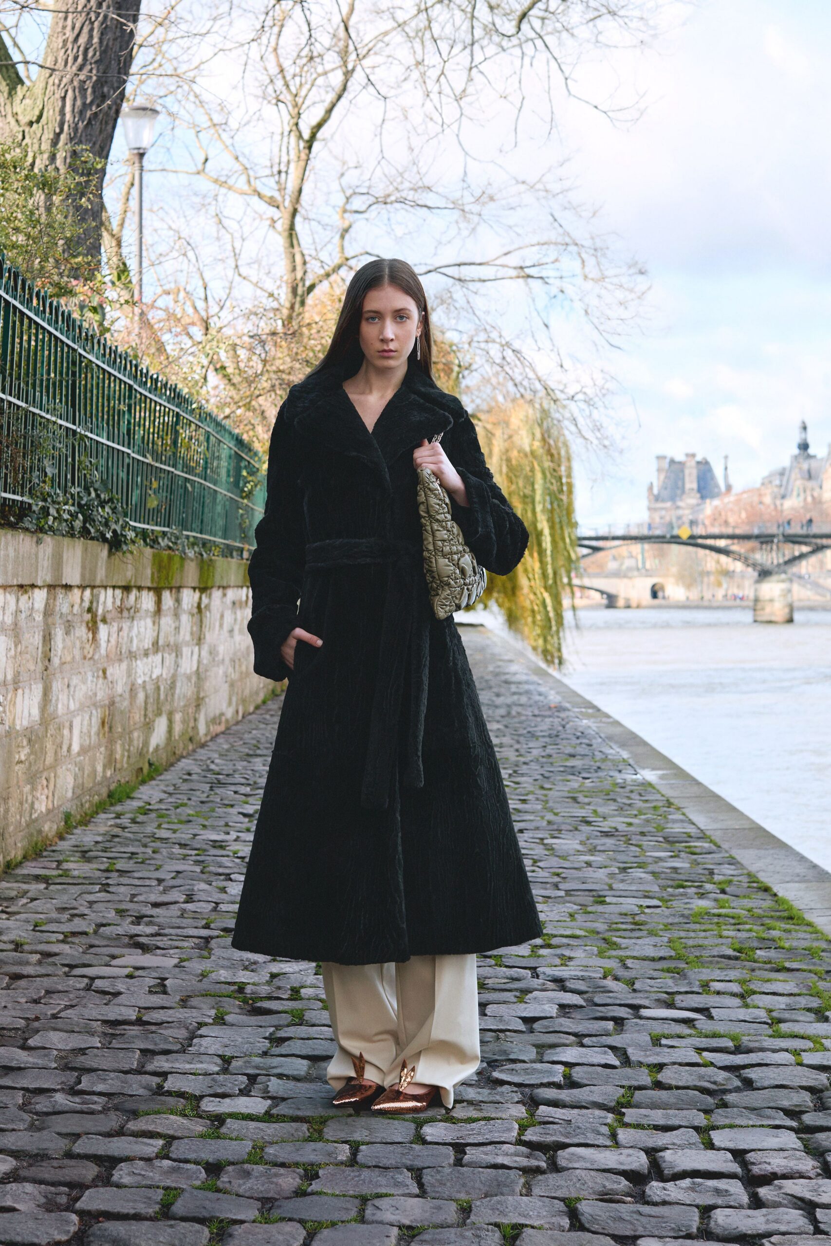 black fur coat with beige pants
