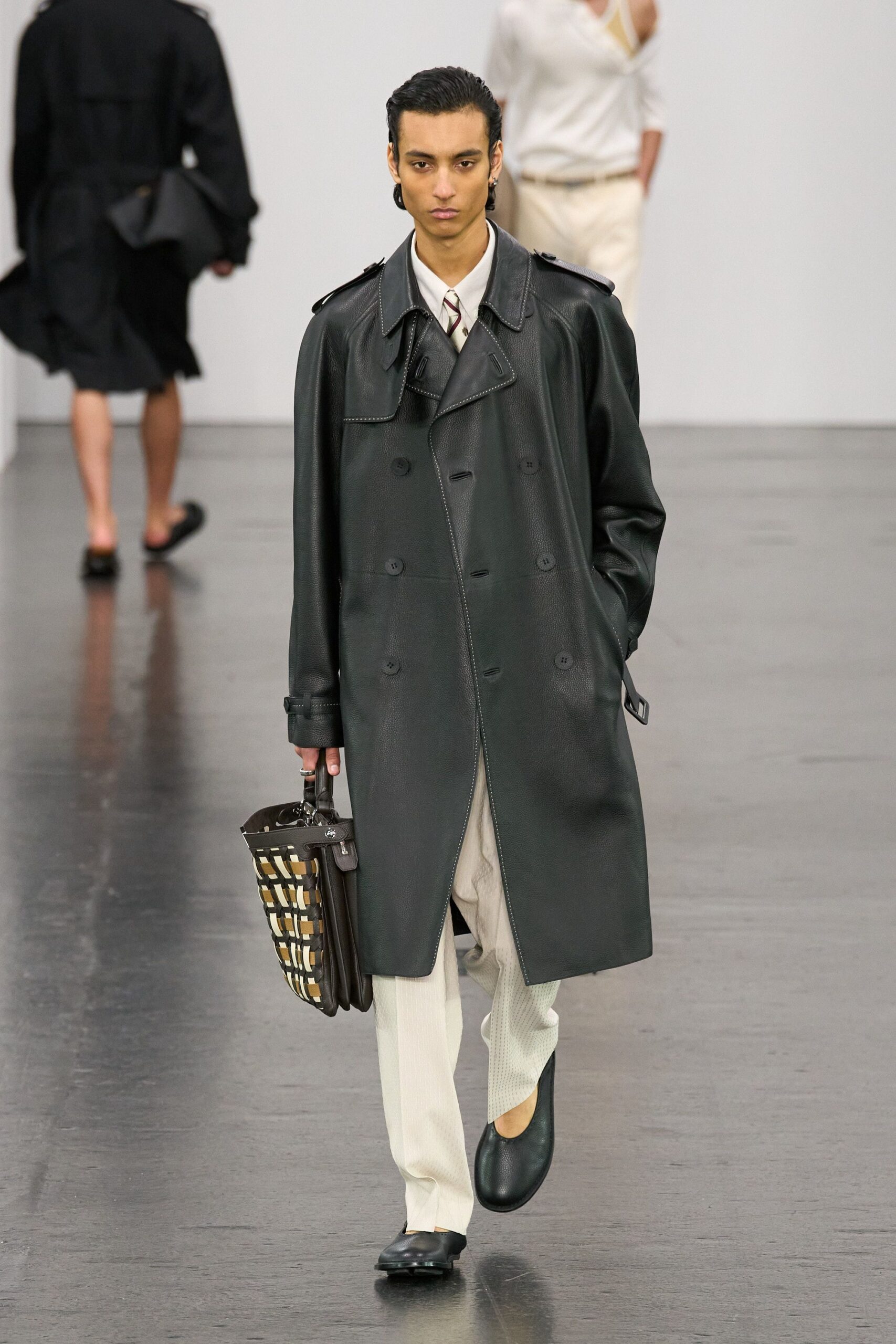 black leather coat with beige pants