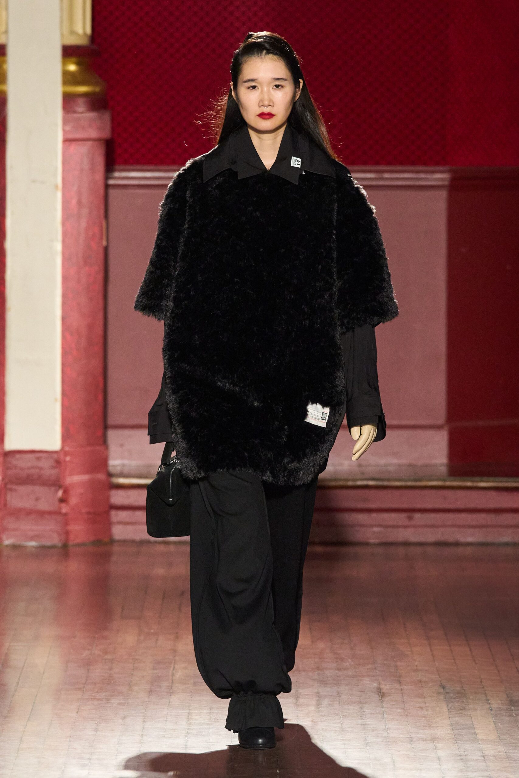 black faux-fur coat with relaxed pants