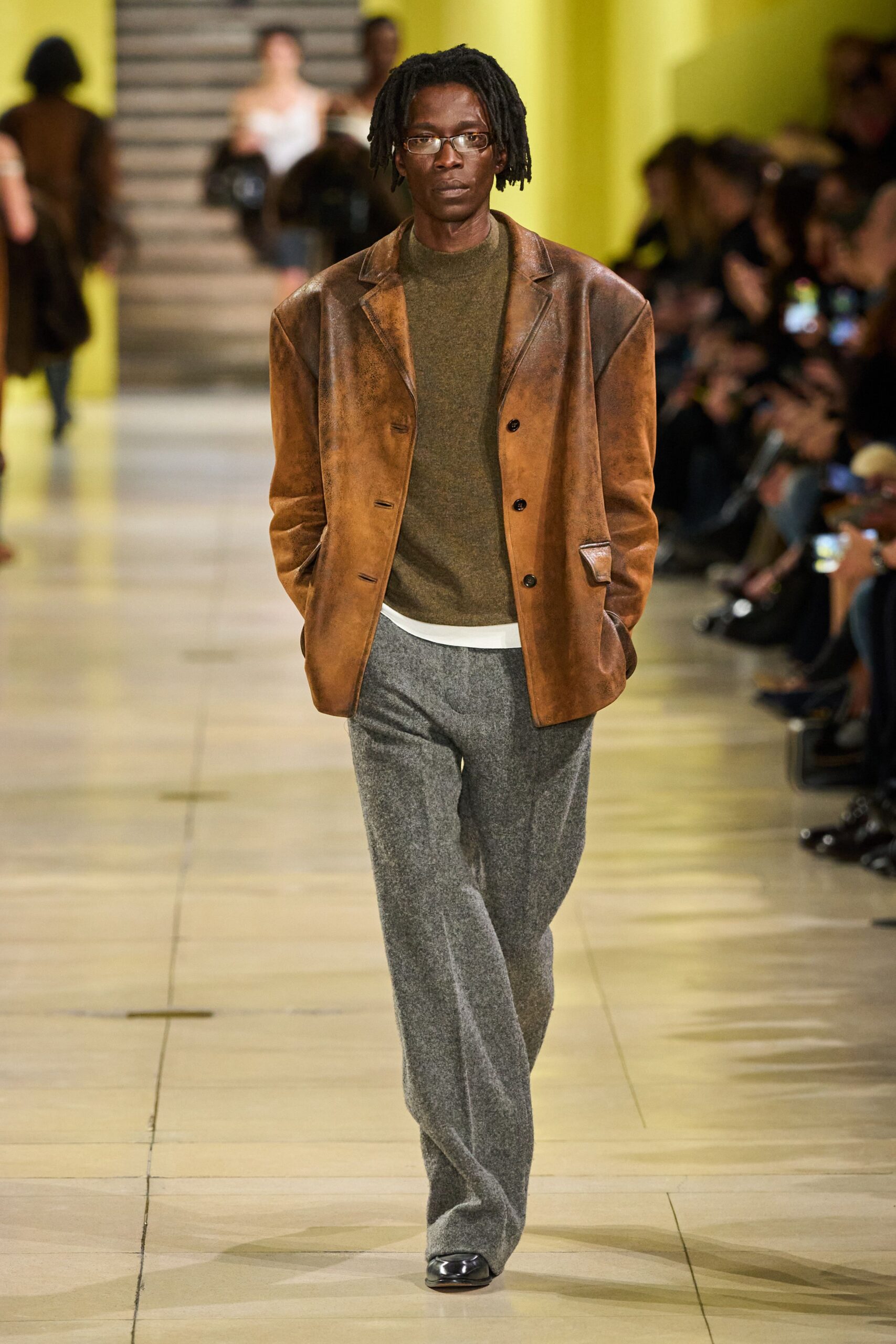 brown leather jacket with gray pants