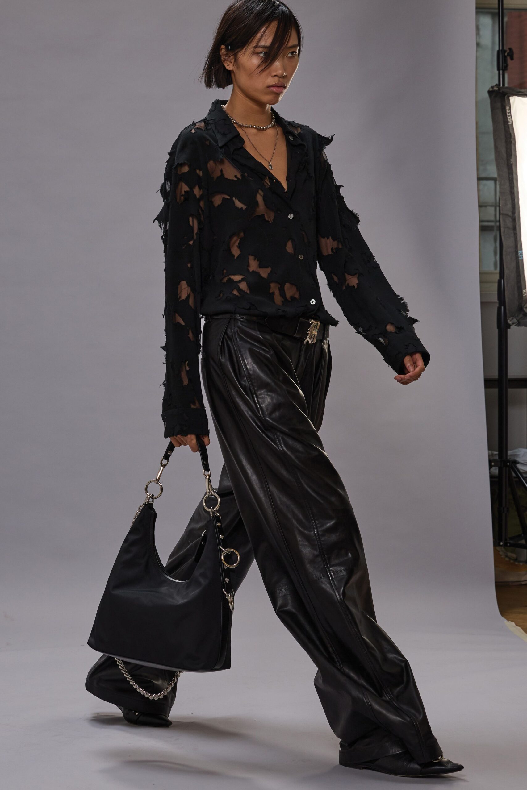 black distressed shirt and leather pants
