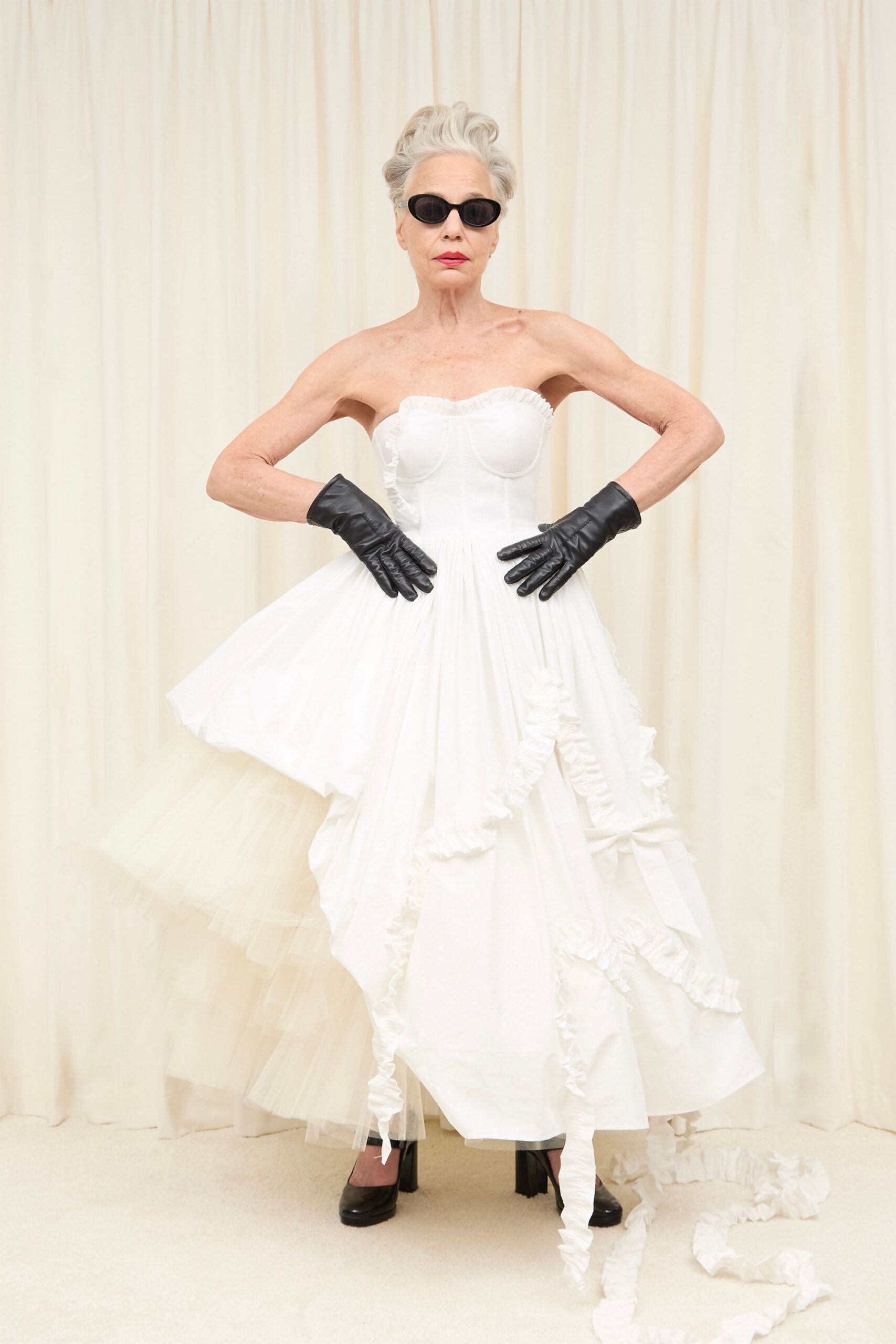 white silk strapless fitted ruffled layered flowing gown