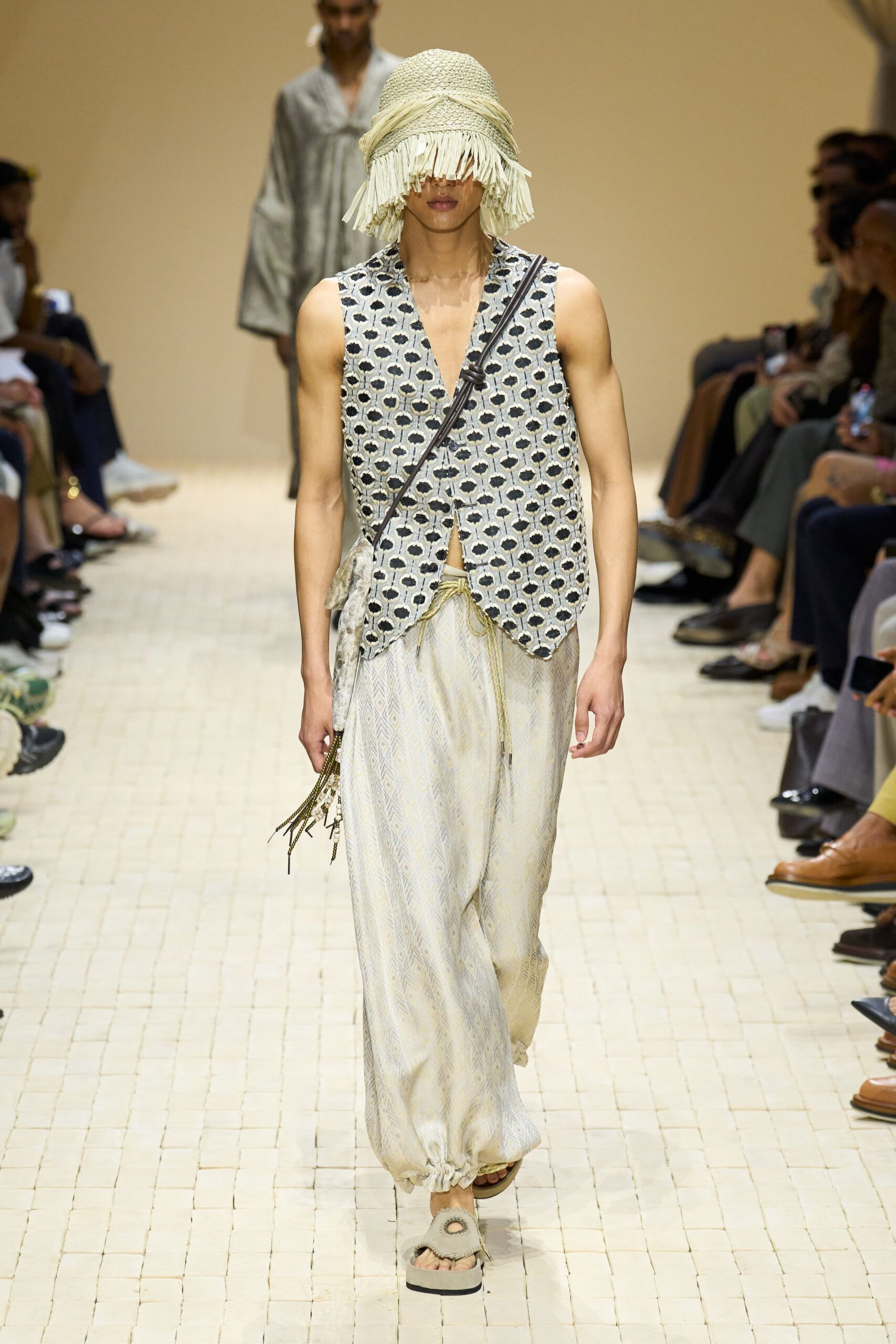 white printed vest with beige pants