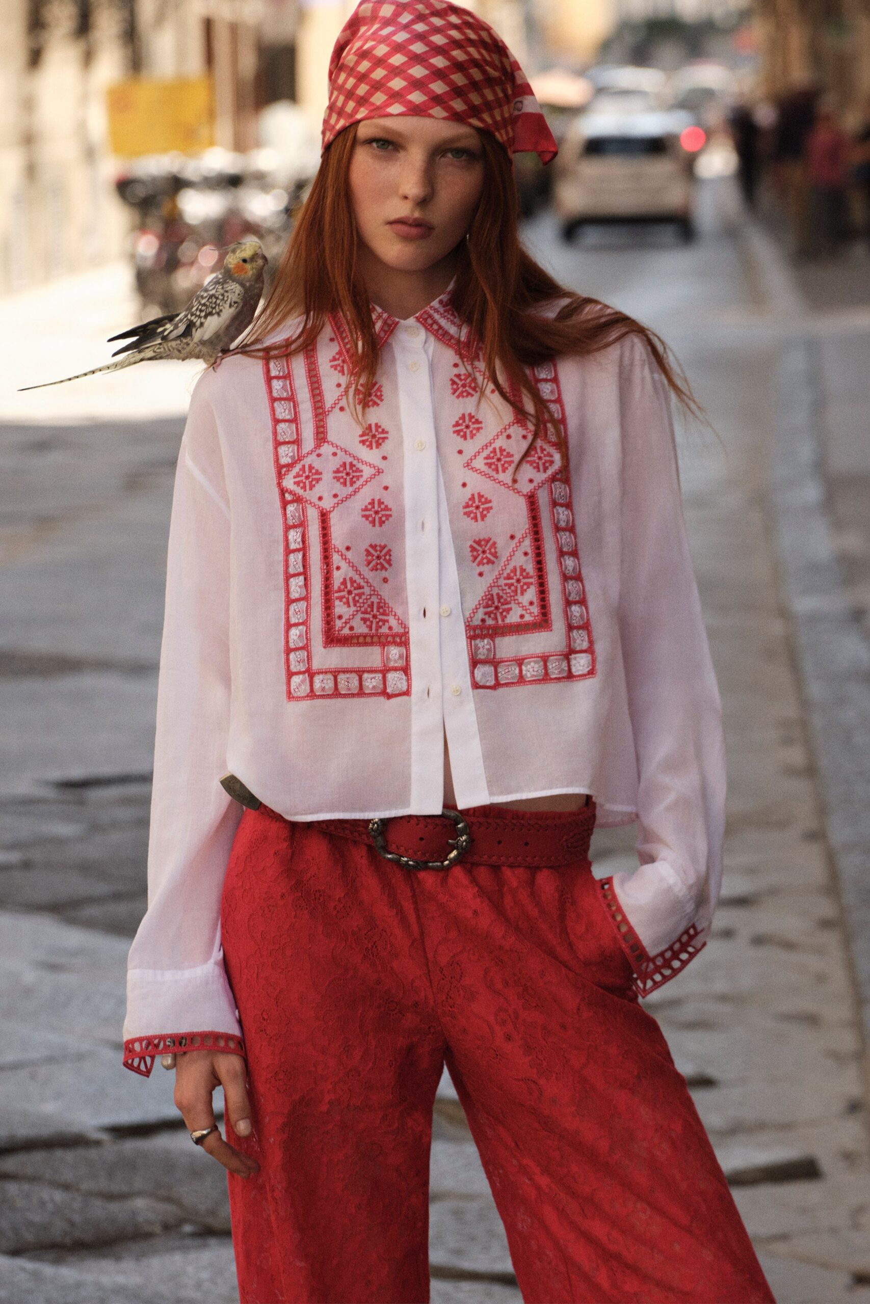 white embroidered shirt with red pants