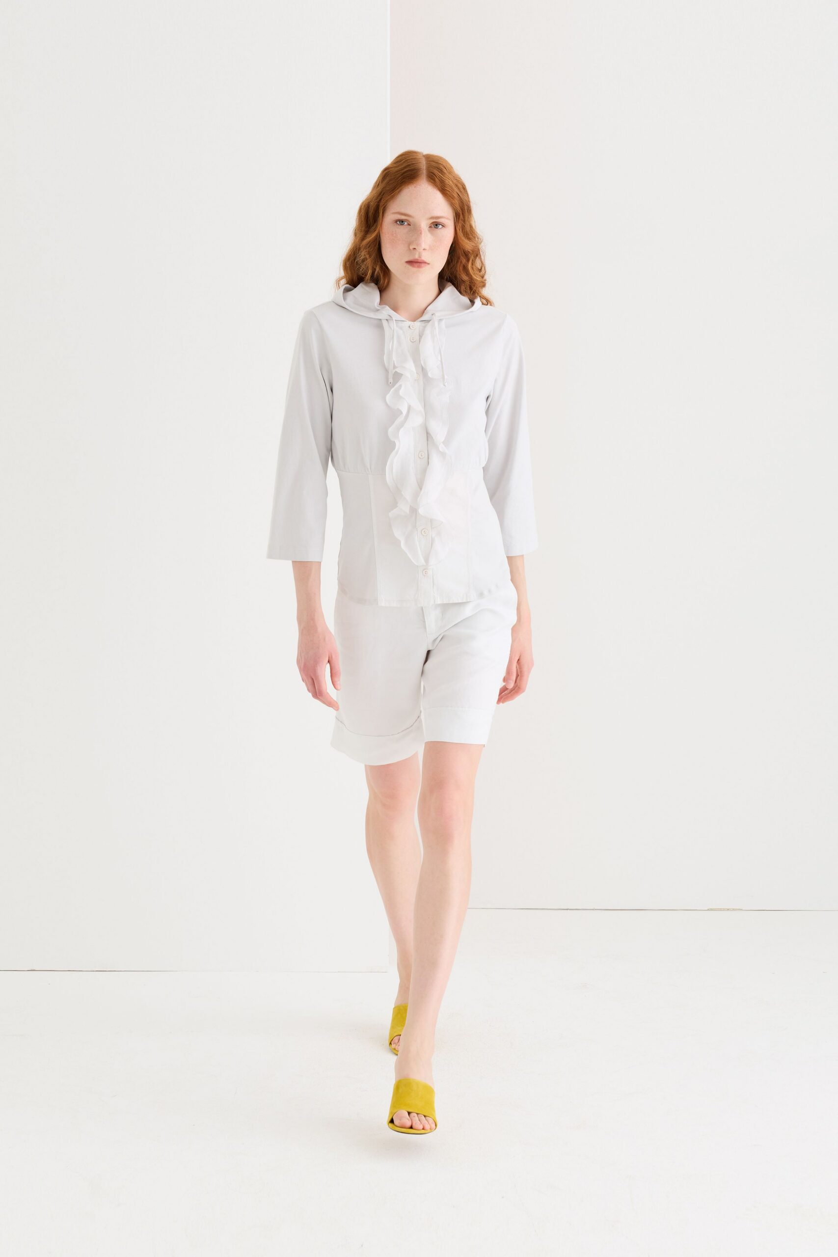 white fitted top with ruffles and yellow shoes