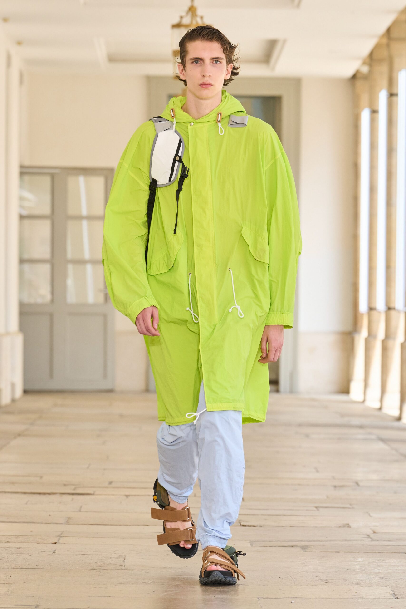 green nylon coat with brown shoes
