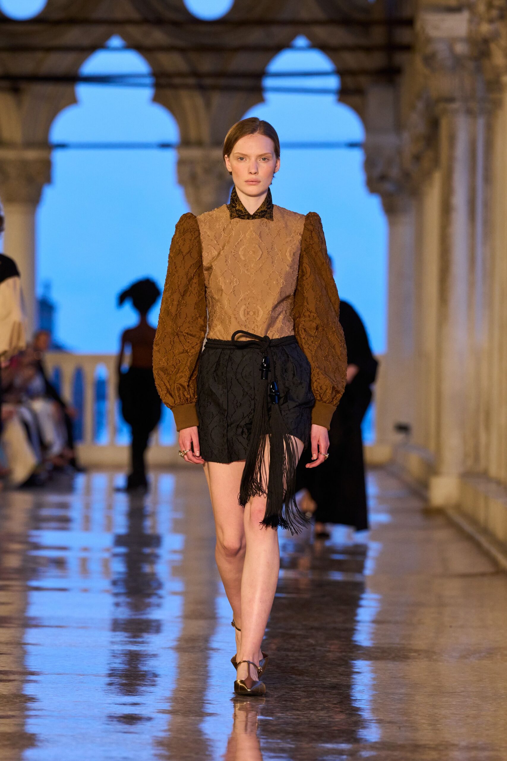 brown embroidered top with black shorts