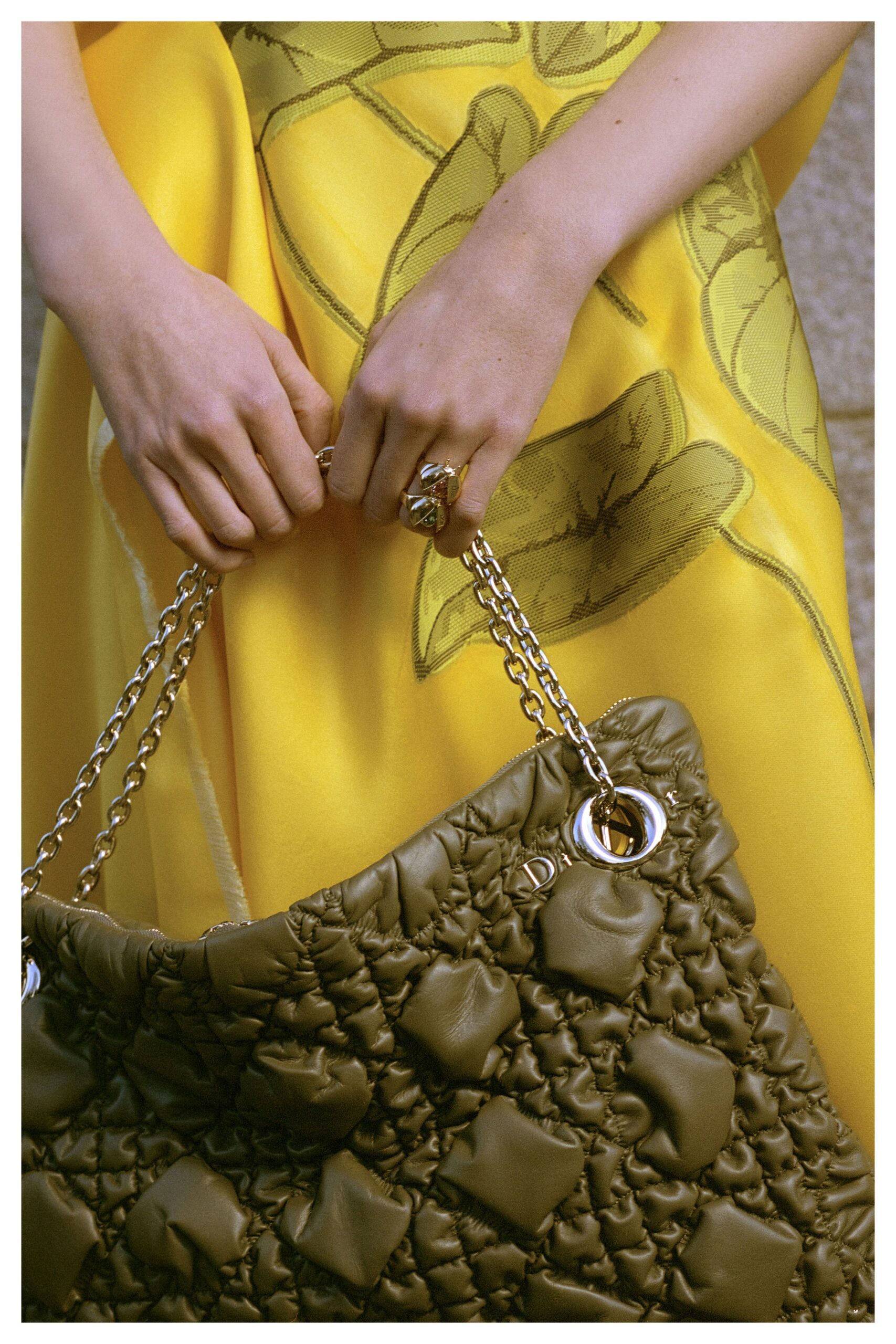 yellow embroidered midi dress with green bag