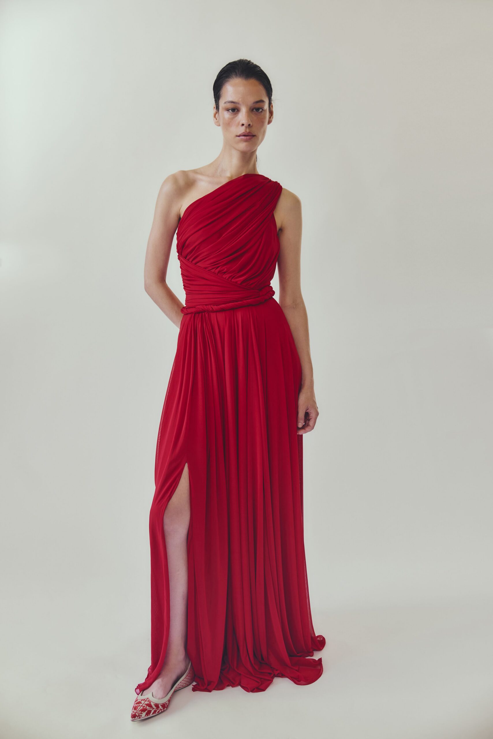 red silk sleeveless asymmetric fitted draped flowing gown