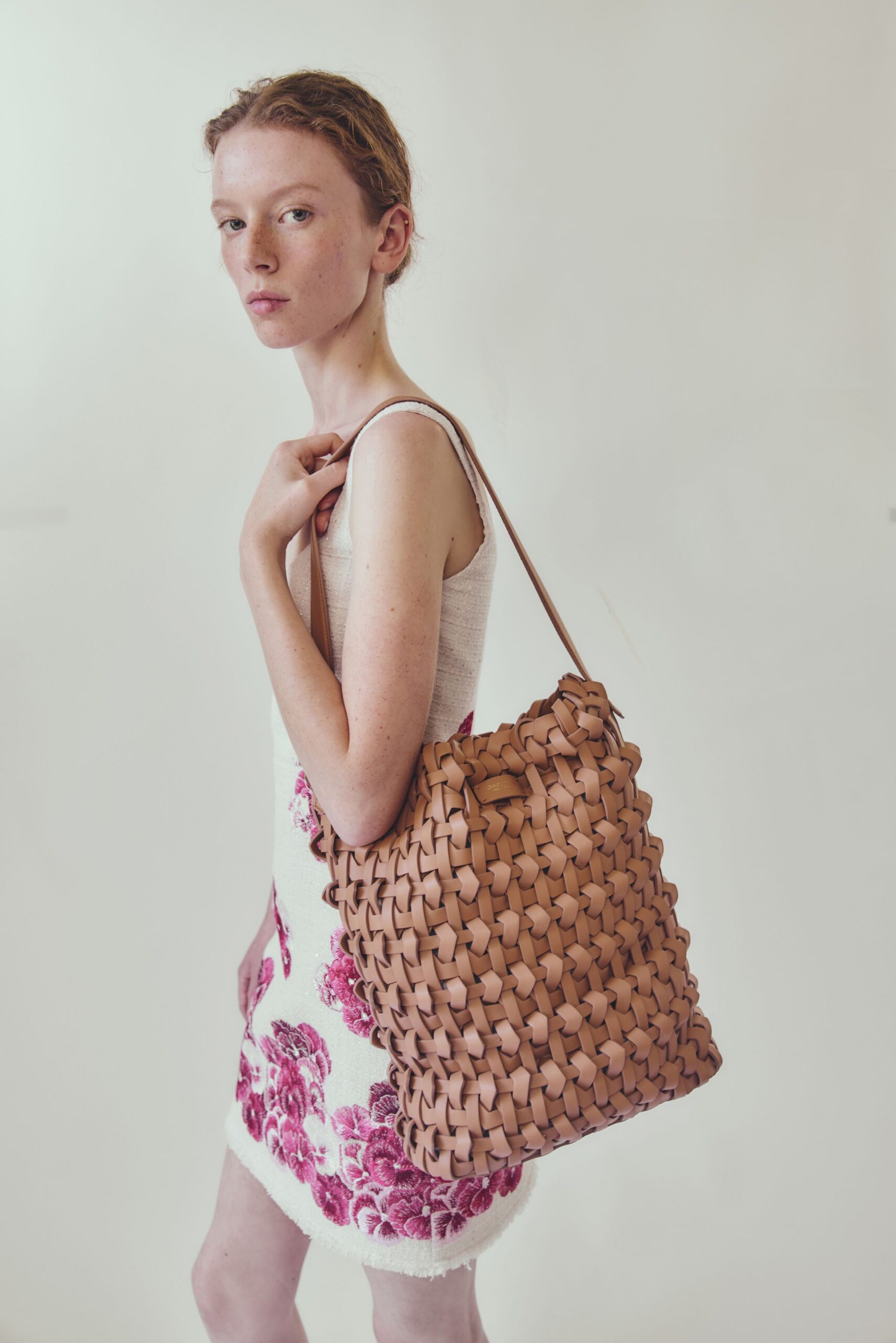 white pink embroidered mini dress with brown bag